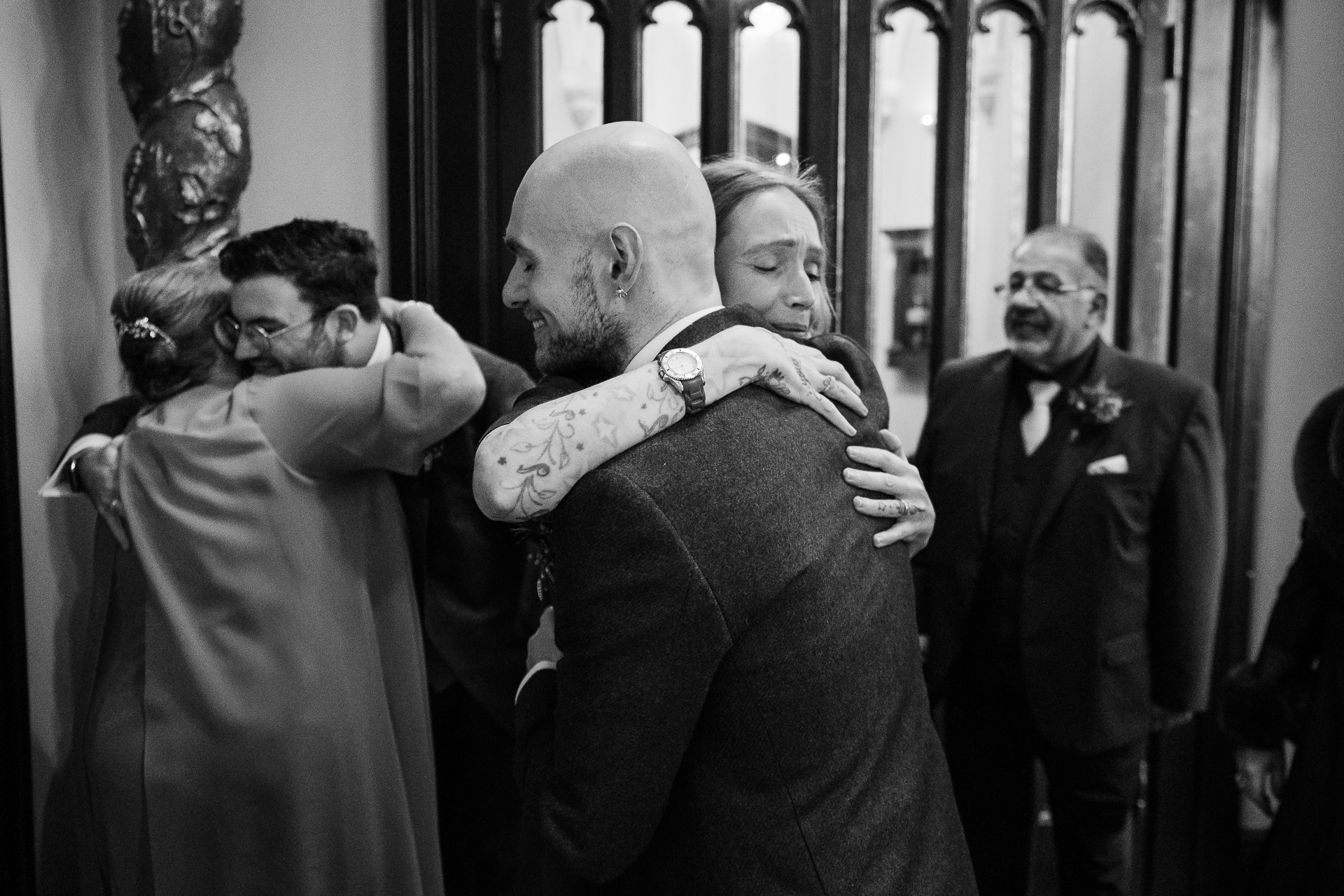 A man in a suit and tie holding another man's hand