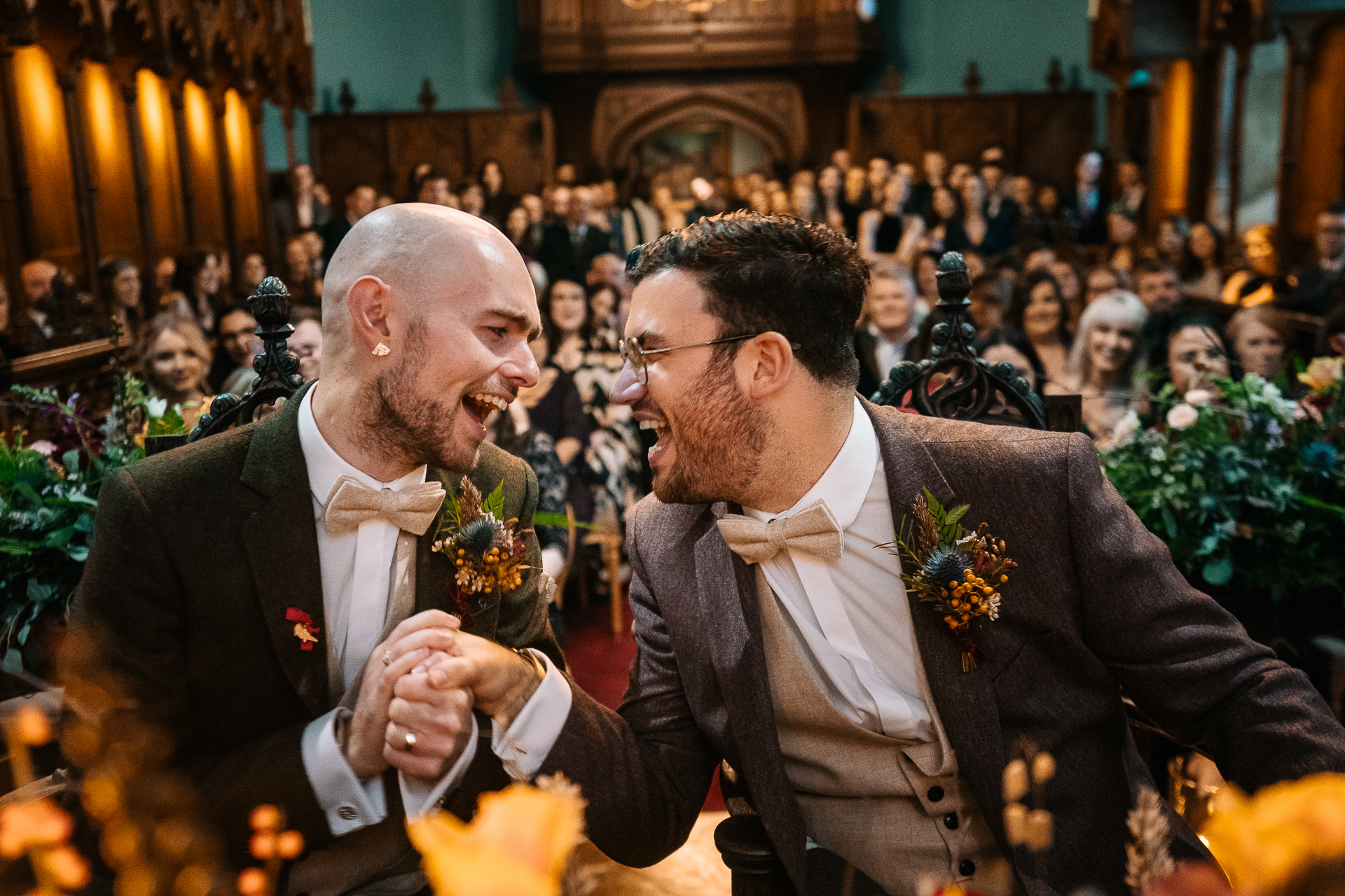 A man in a suit laughing at another man in a suit