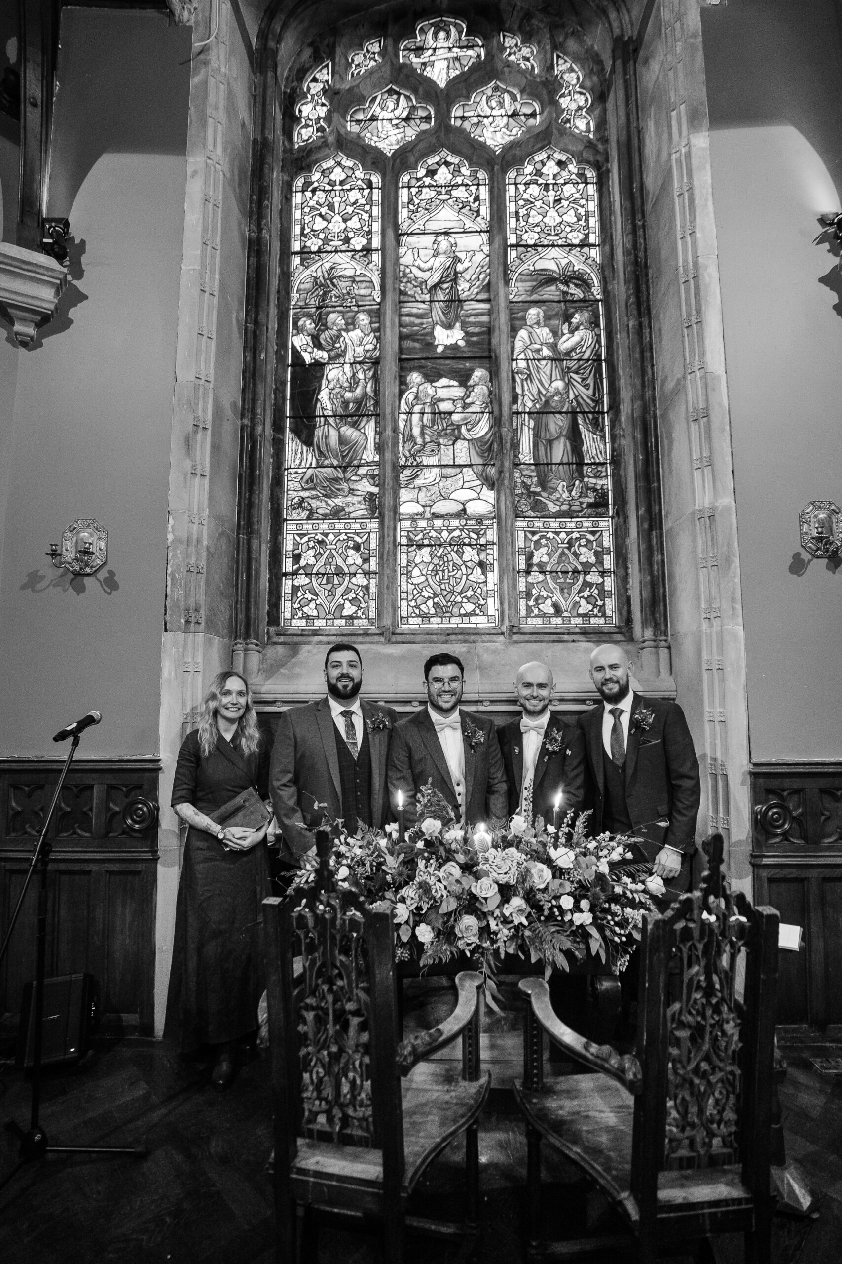 A group of people standing in front of a window