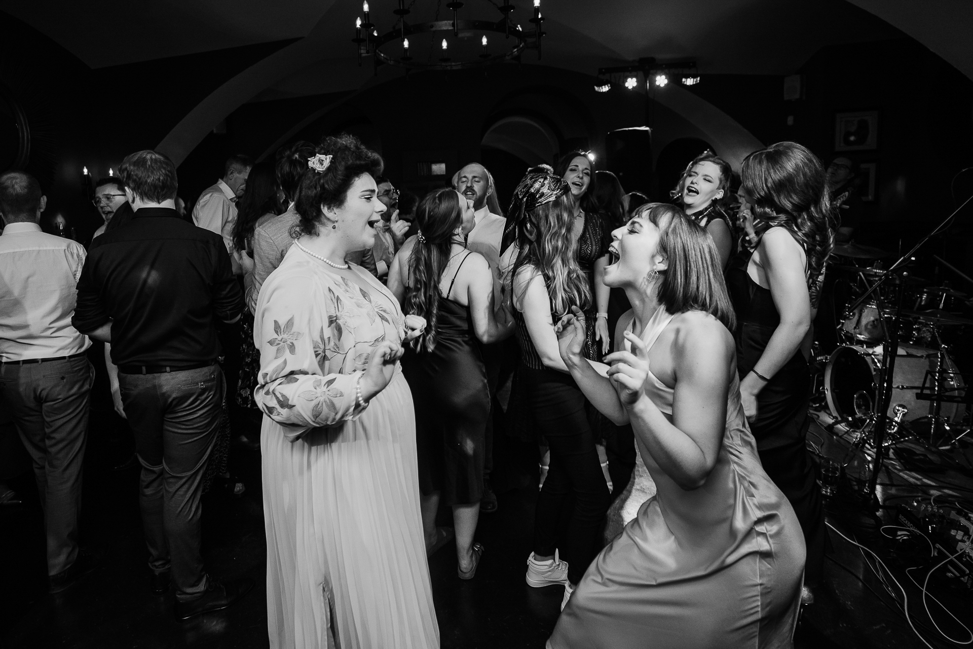 A group of people dancing with Studio 54 in the background