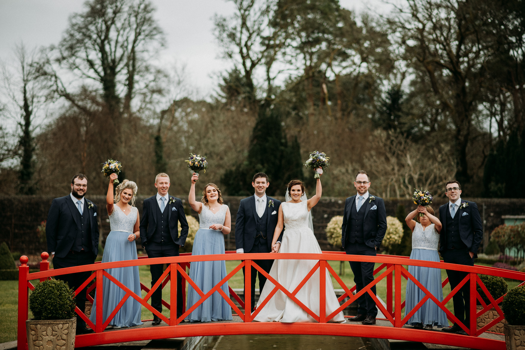 A group of people standing next to a fence