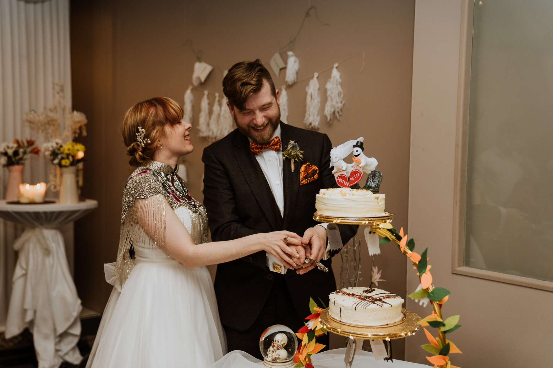 A person cutting a wedding cake