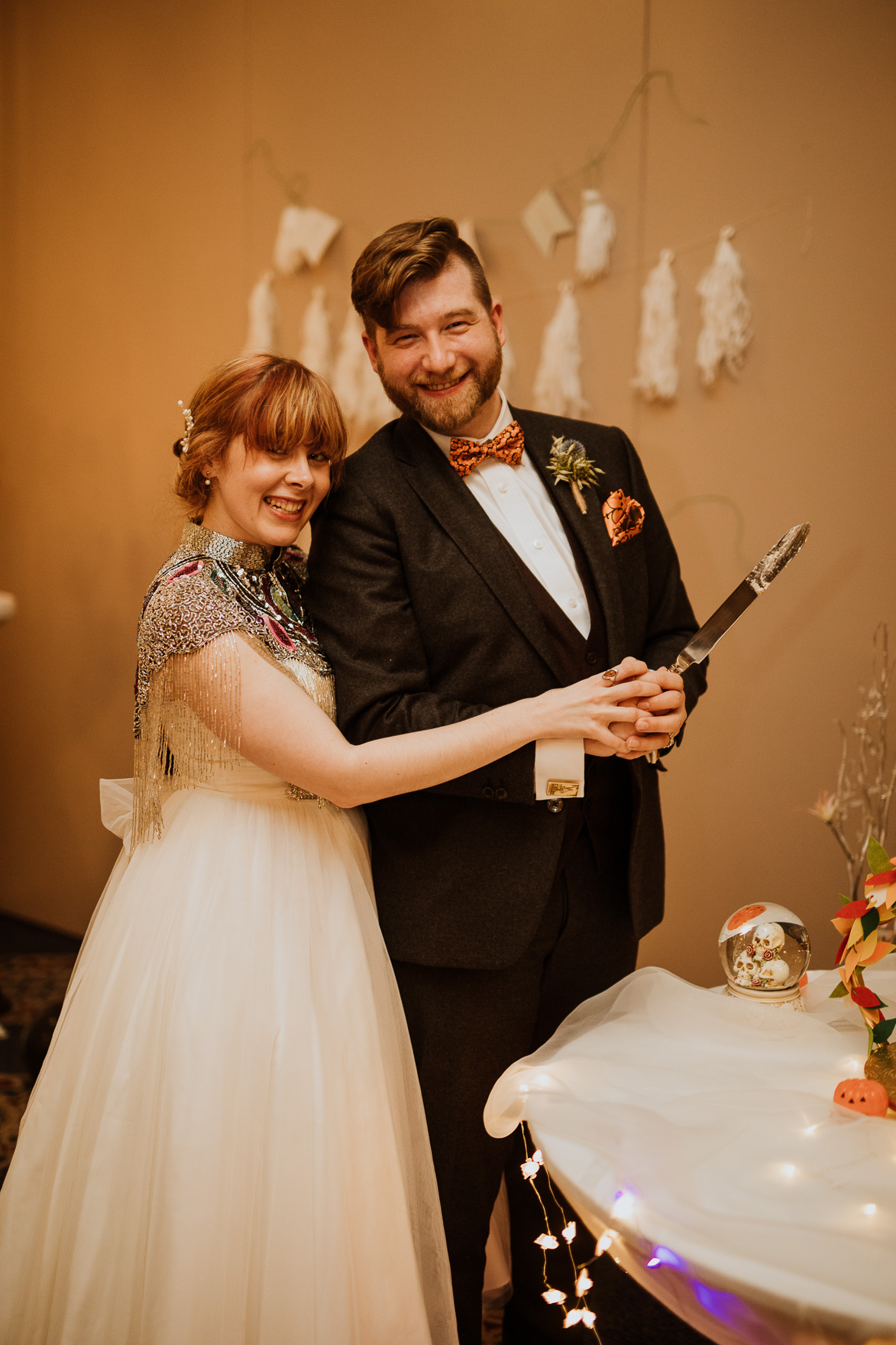 A man and woman cutting a wedding cake