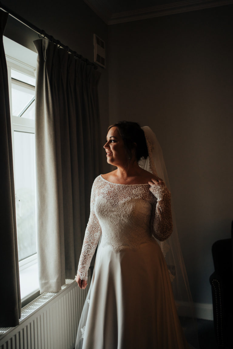 A woman standing in front of a mirror posing for the camera