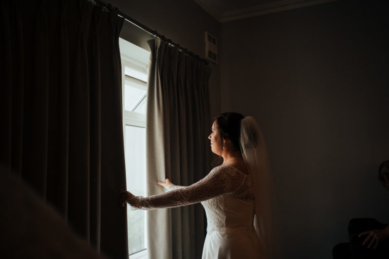 A person standing in front of a window