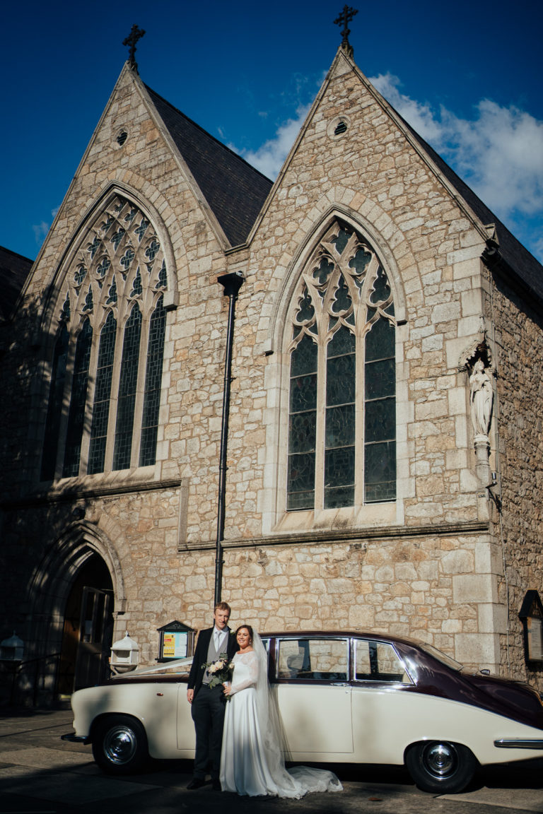 A car parked in front of a church