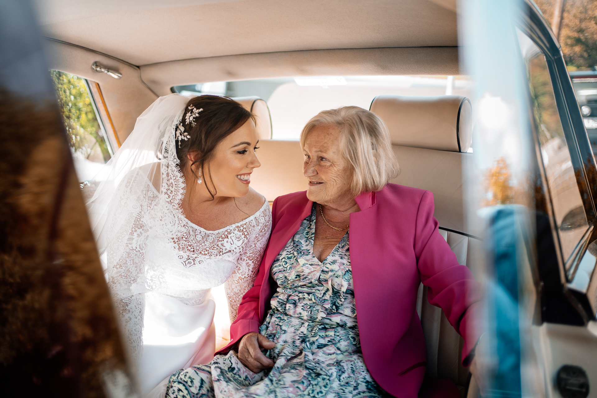 A person in a pink dress and a person in a white dress