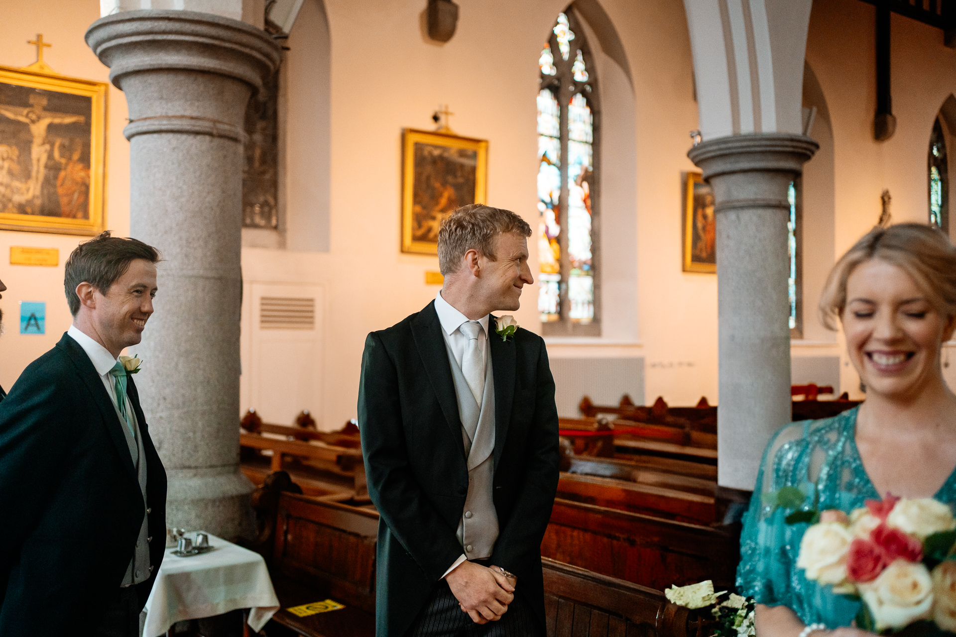 A man in a suit and a woman in a dress in a church