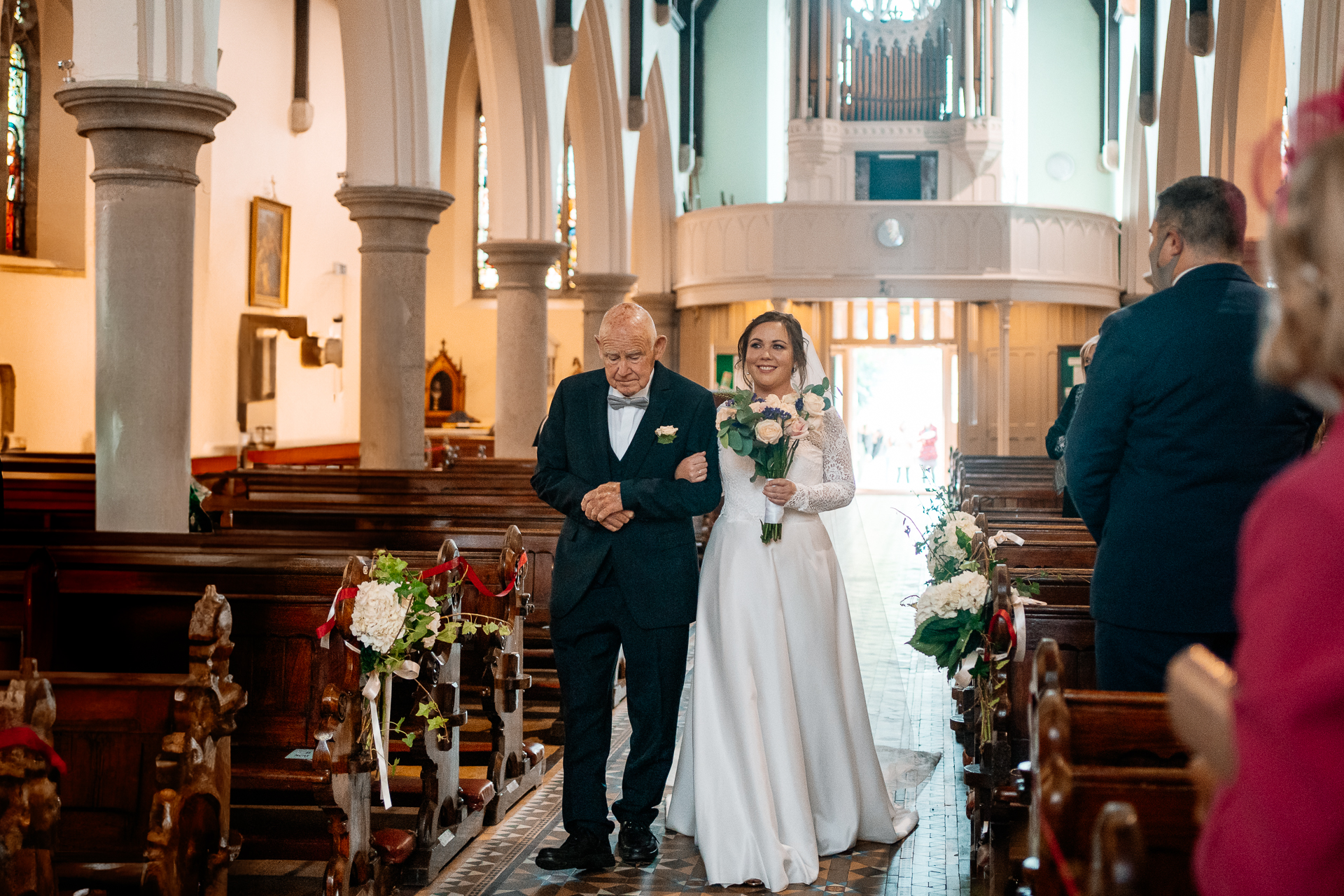 A man and woman walking down a aisle