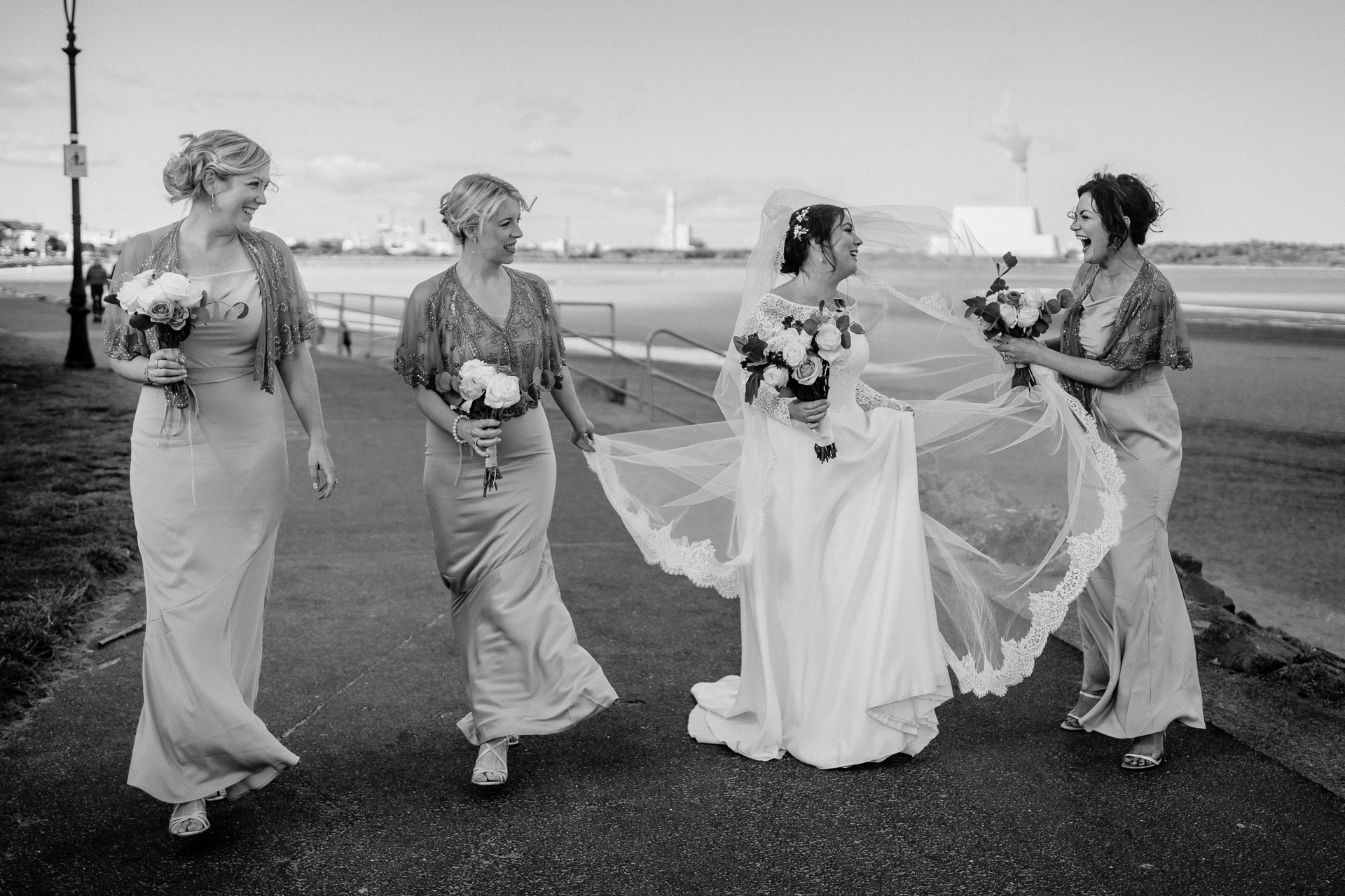 A group of women walking down a road