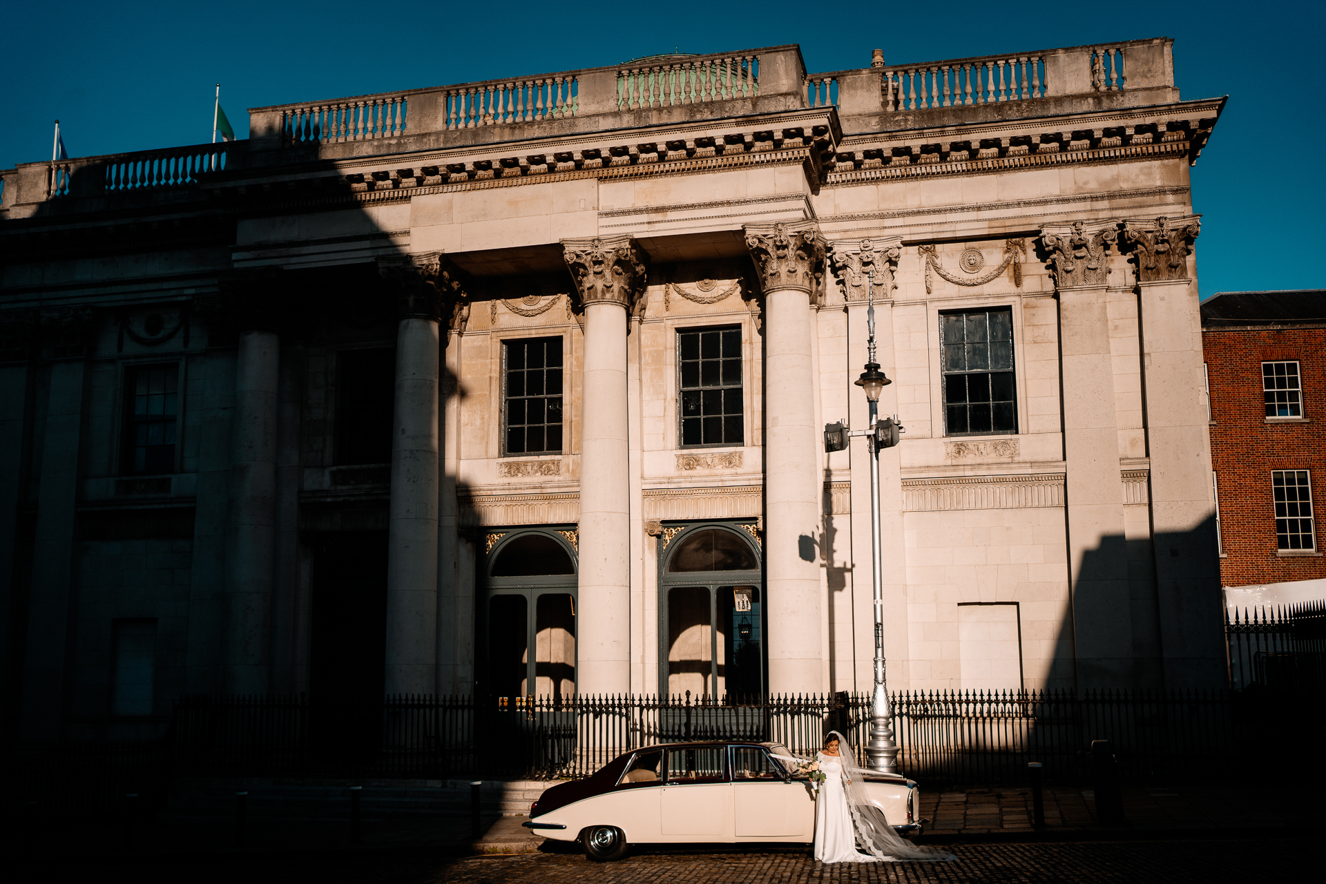 A white car parked in front of a building