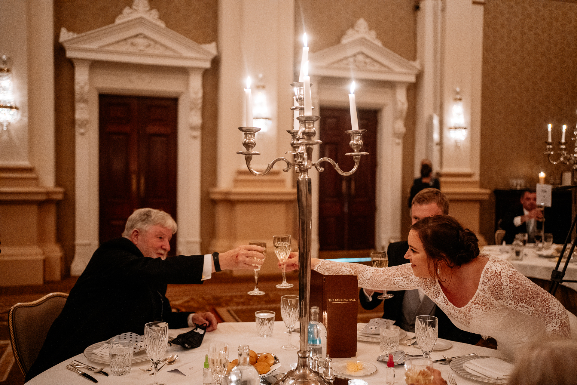 A man and woman sitting at a table with wine glasses