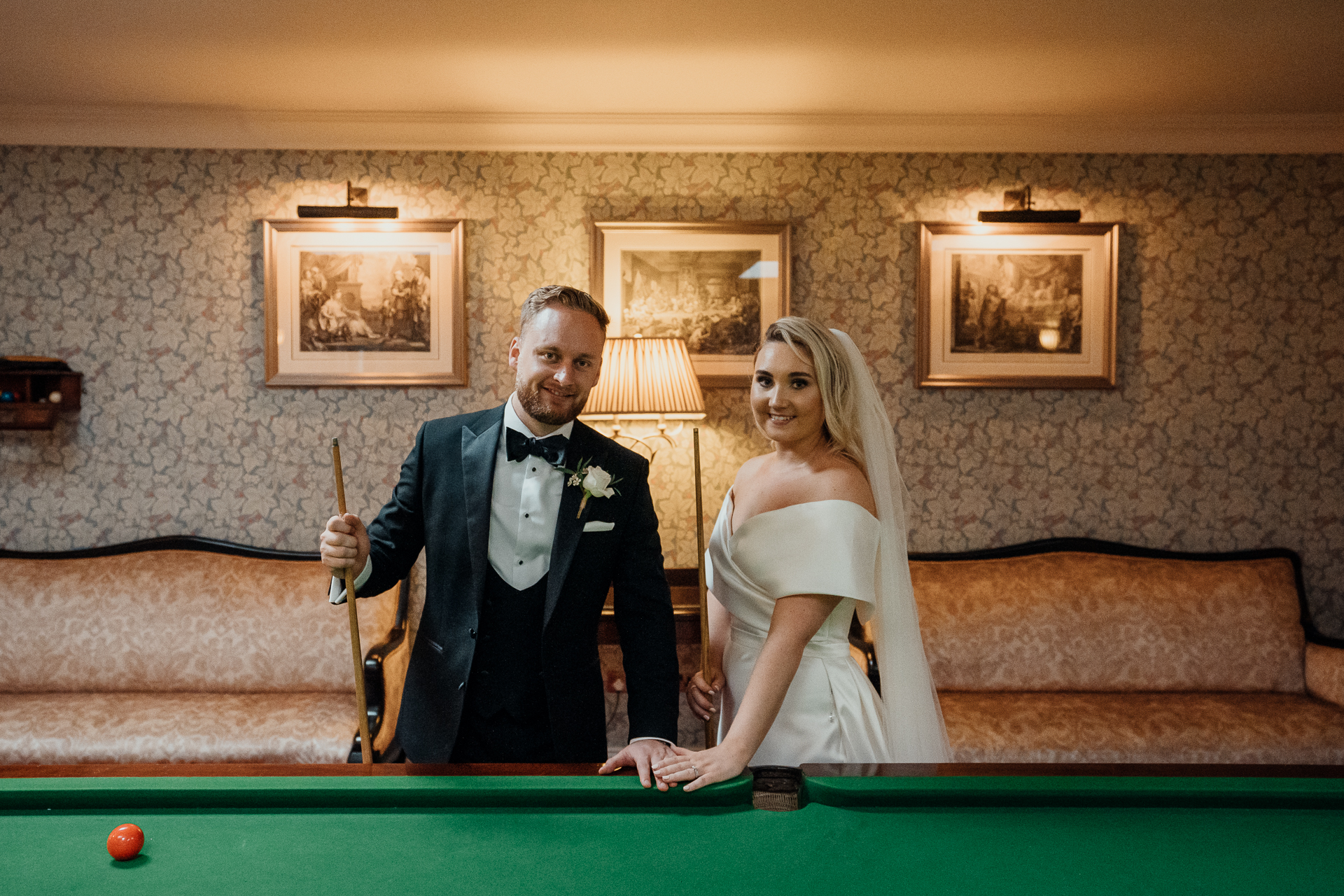 Bride and groom pose with a pool cue inside the Billiard Room at Markree Castle