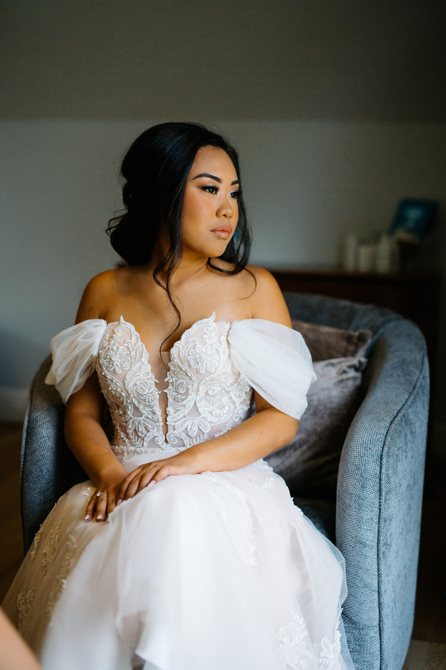 A woman in a white dress sitting on a couch