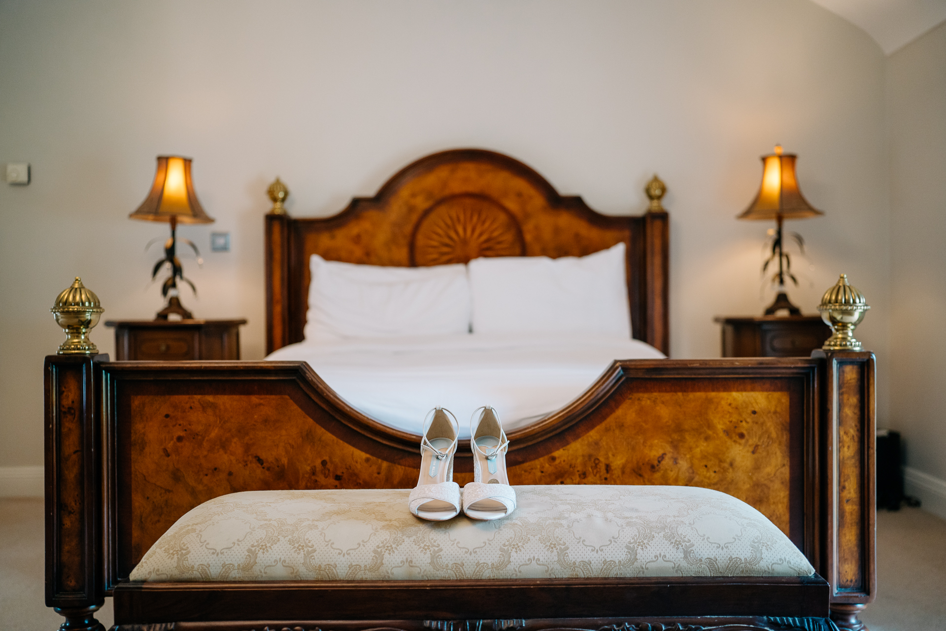 A bed with white shoes on it