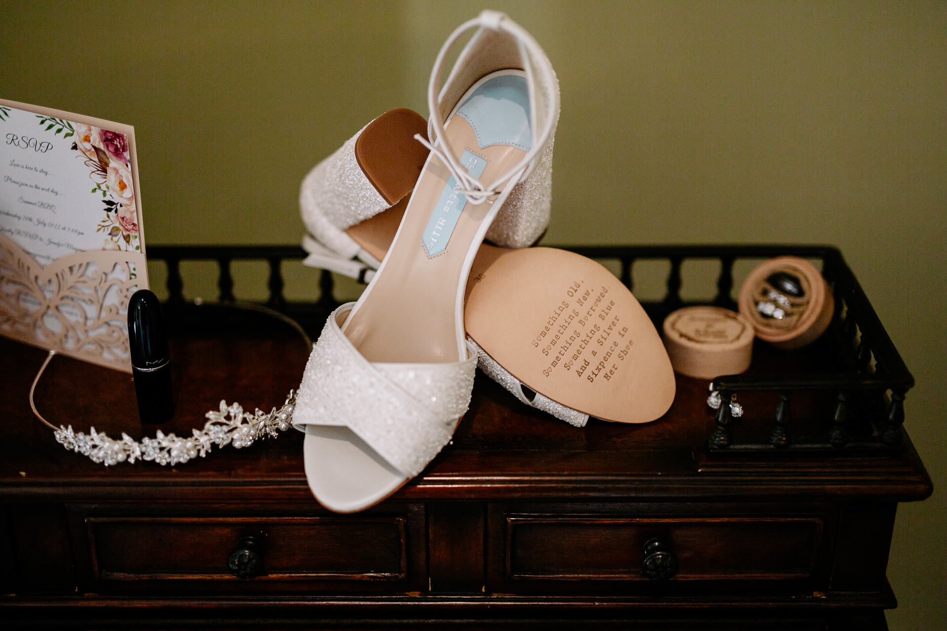 A pair of white shoes on a wooden shelf