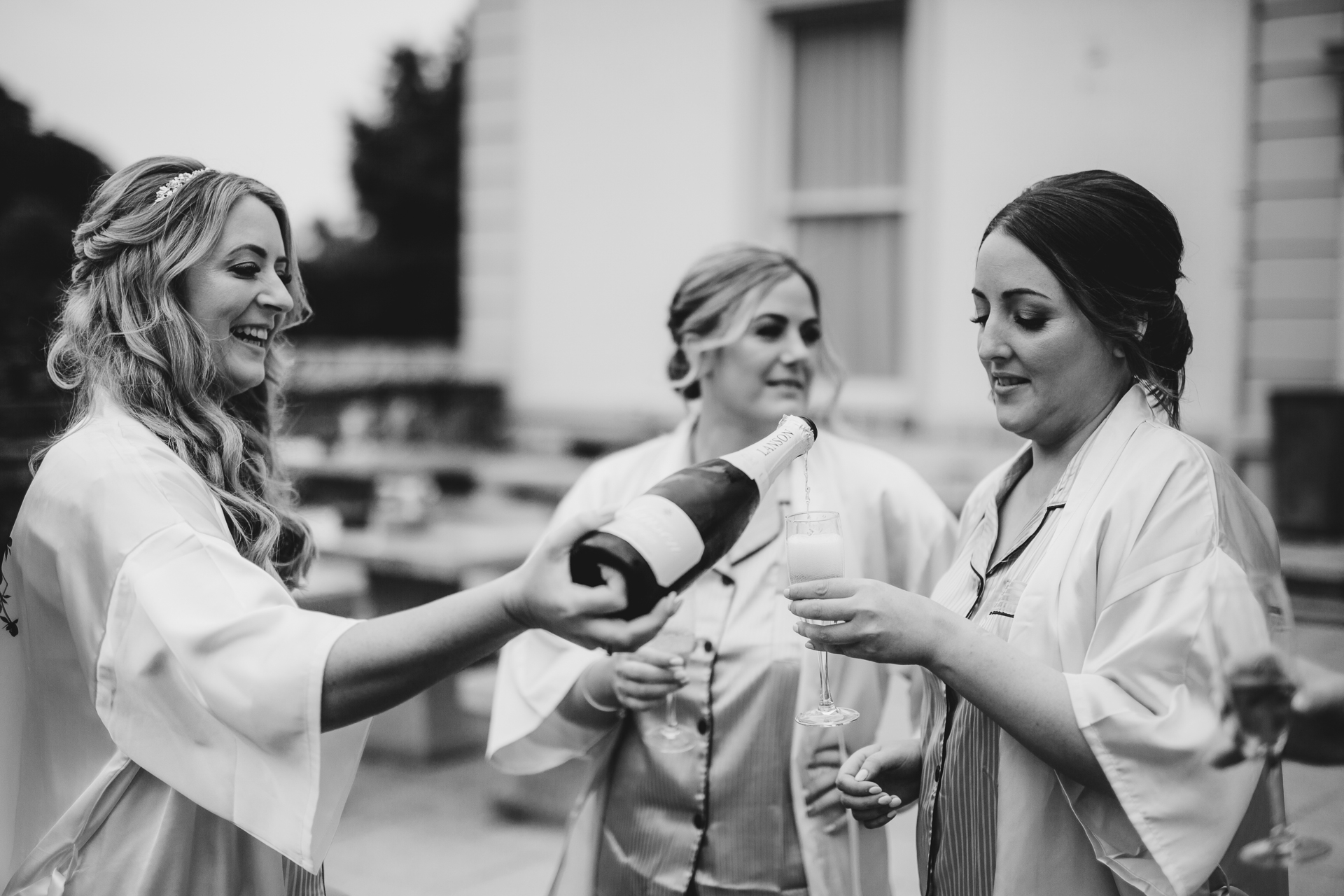 A group of women holding wine glasses