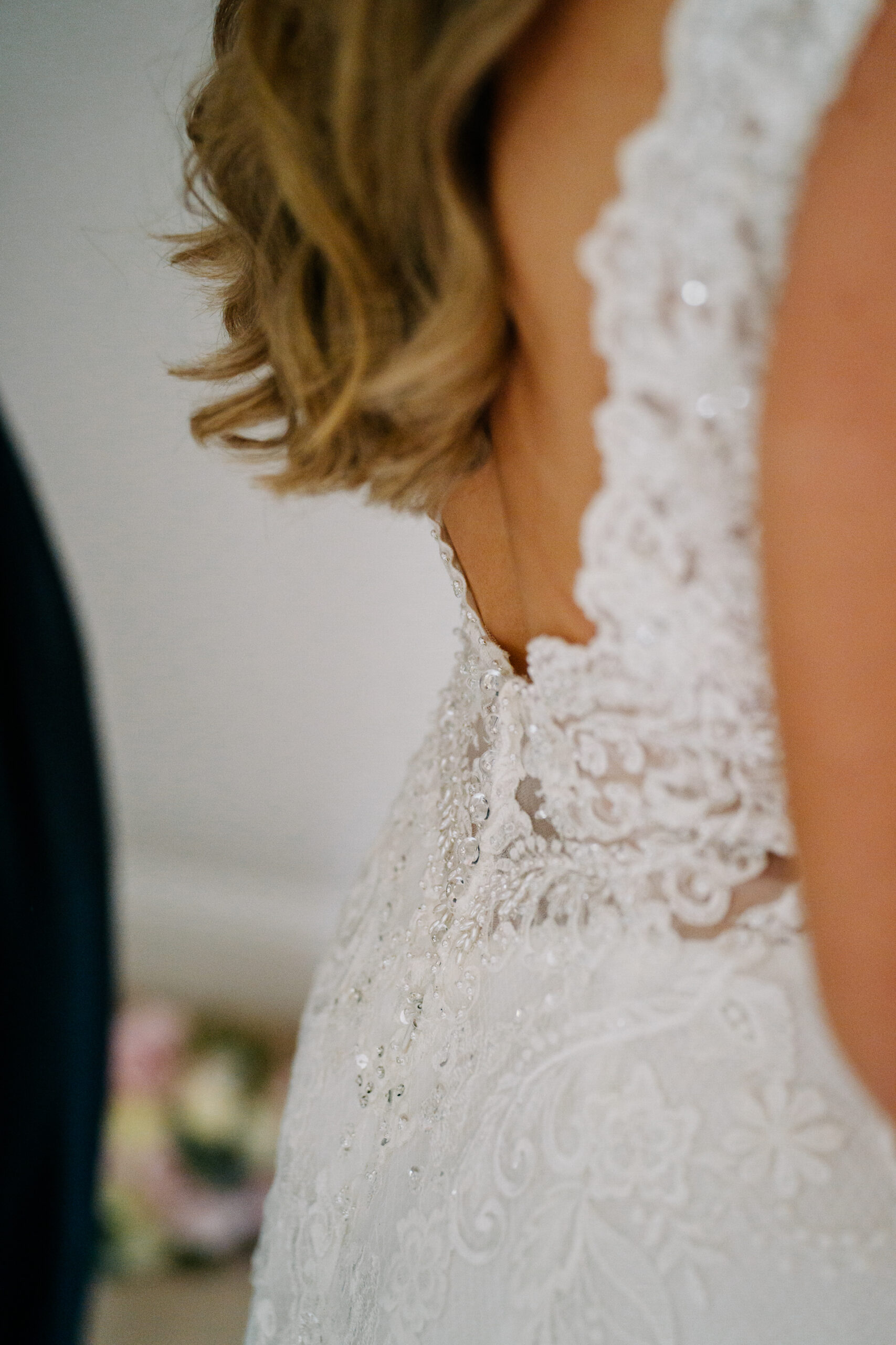 A woman's back with a white dress and a white lace