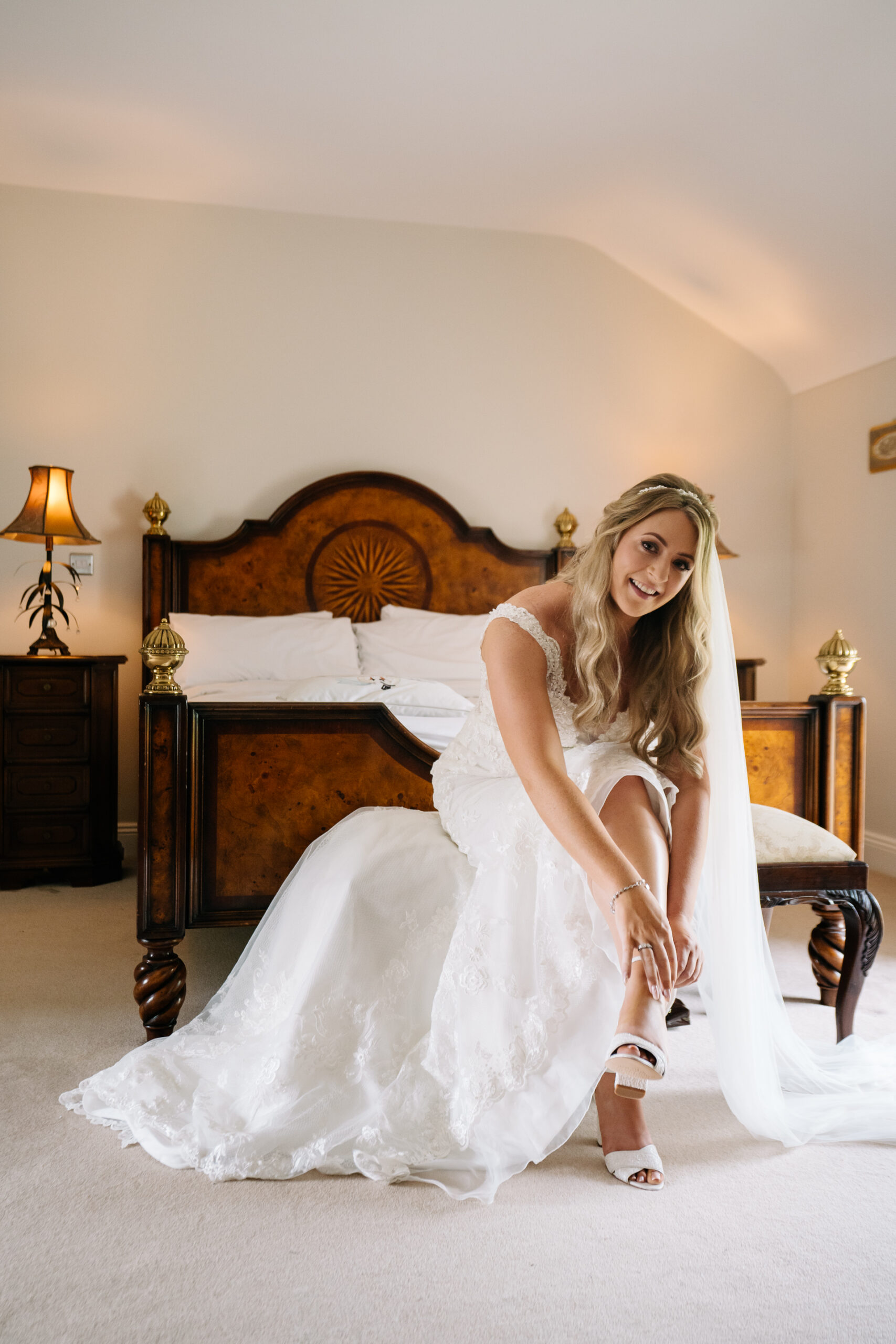 A person in a white dress sitting on a bed