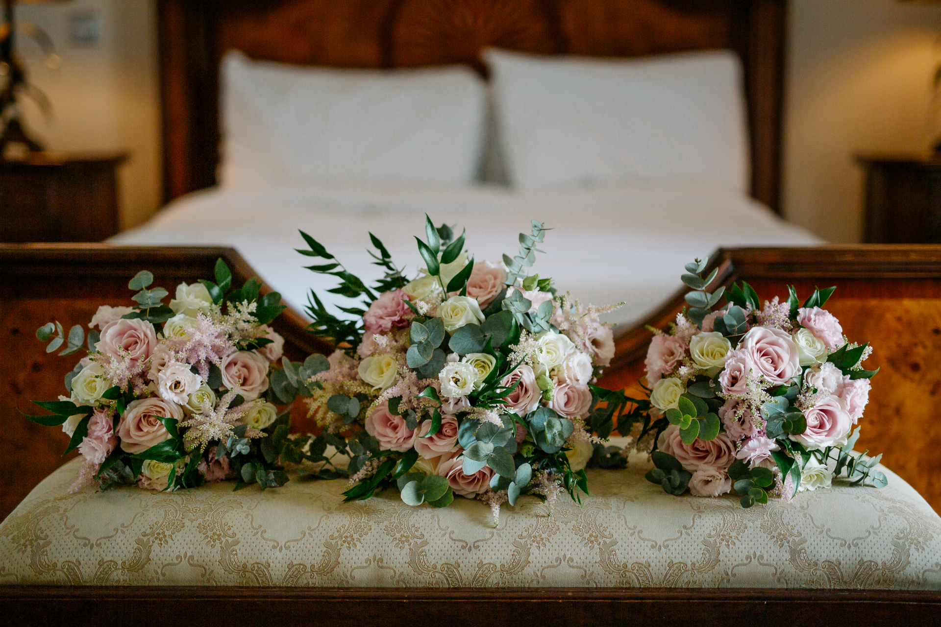 A bouquet of flowers on a bed