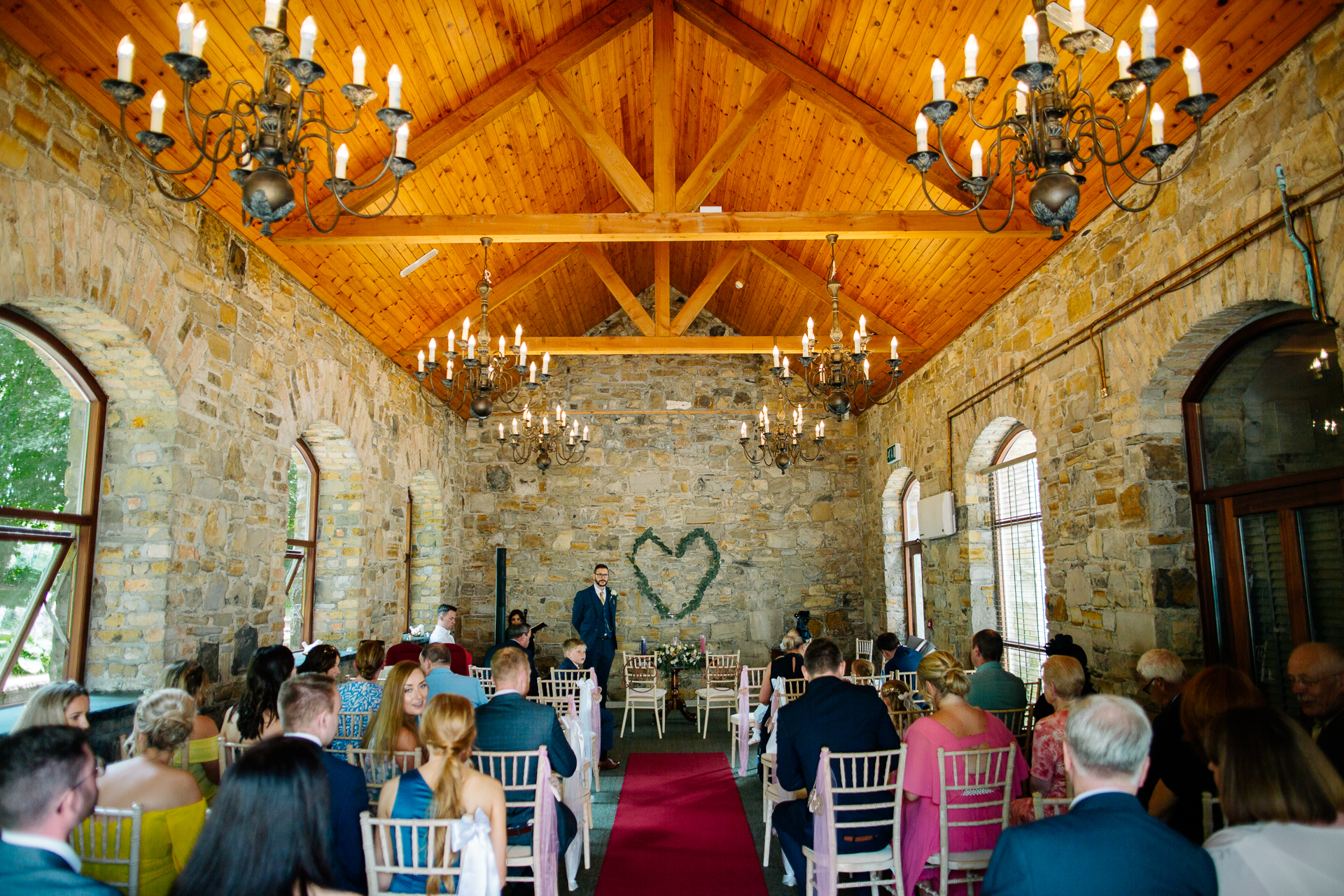 A group of people sitting in a room with chandeliers