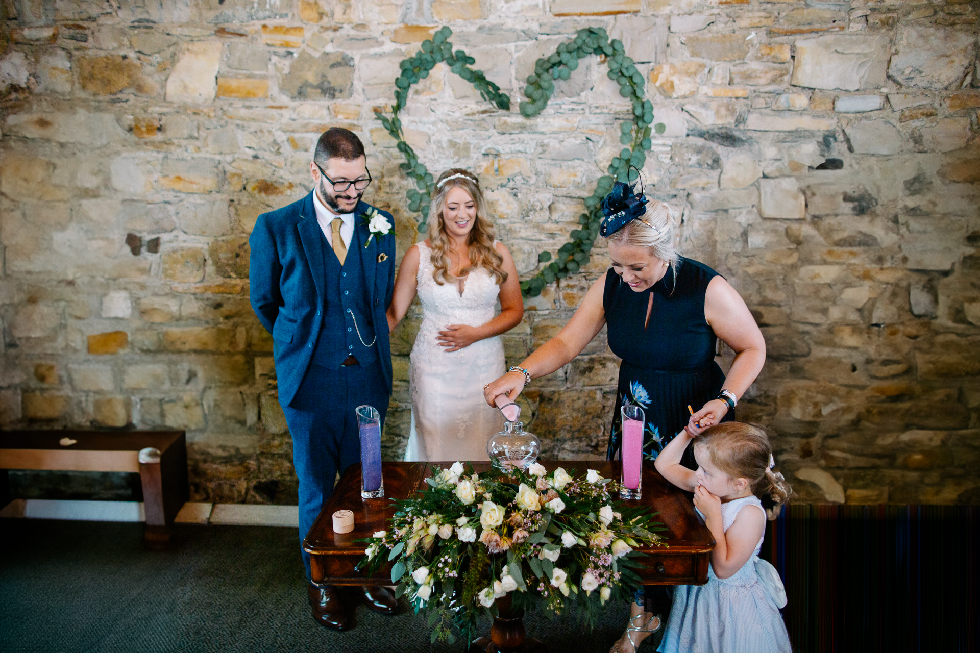 A group of people standing next to a table with flowers