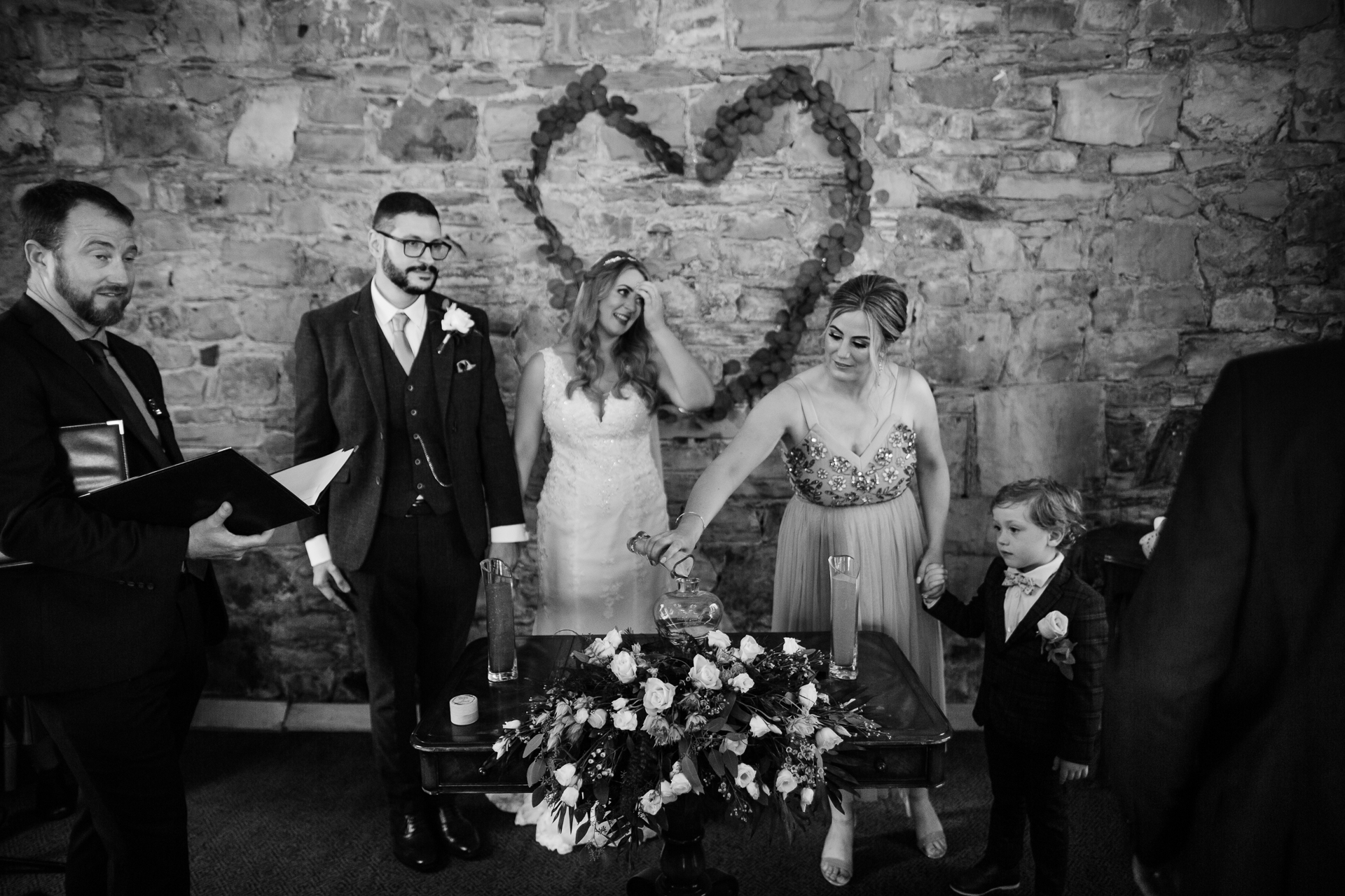 A bride and groom walking down the aisle with their wedding party