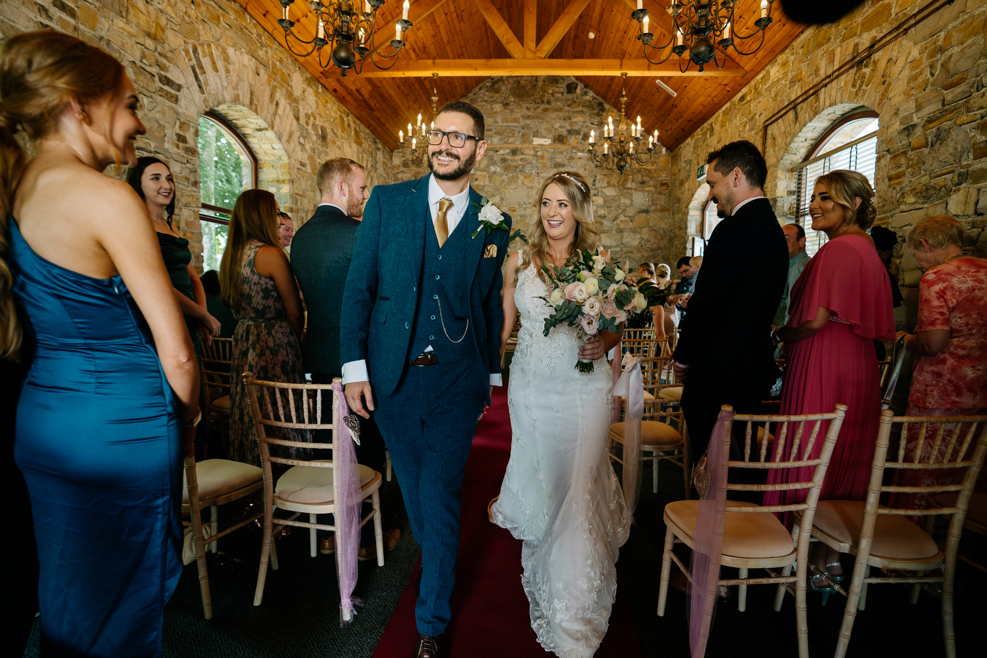 A man and woman walking down a aisle