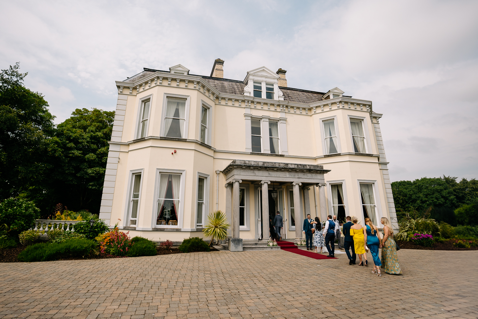 A group of people outside a white building