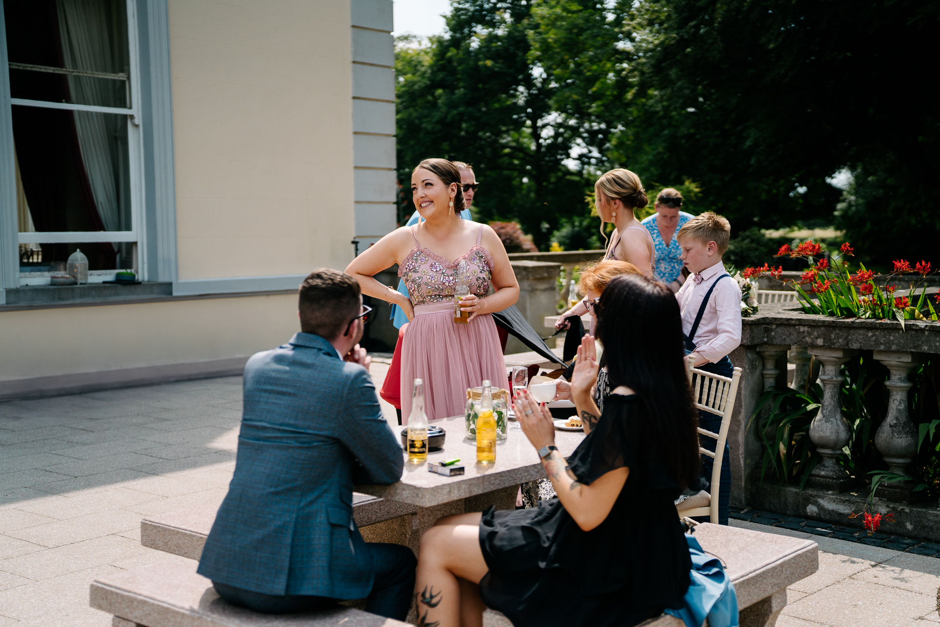 A group of people sitting around a table outside