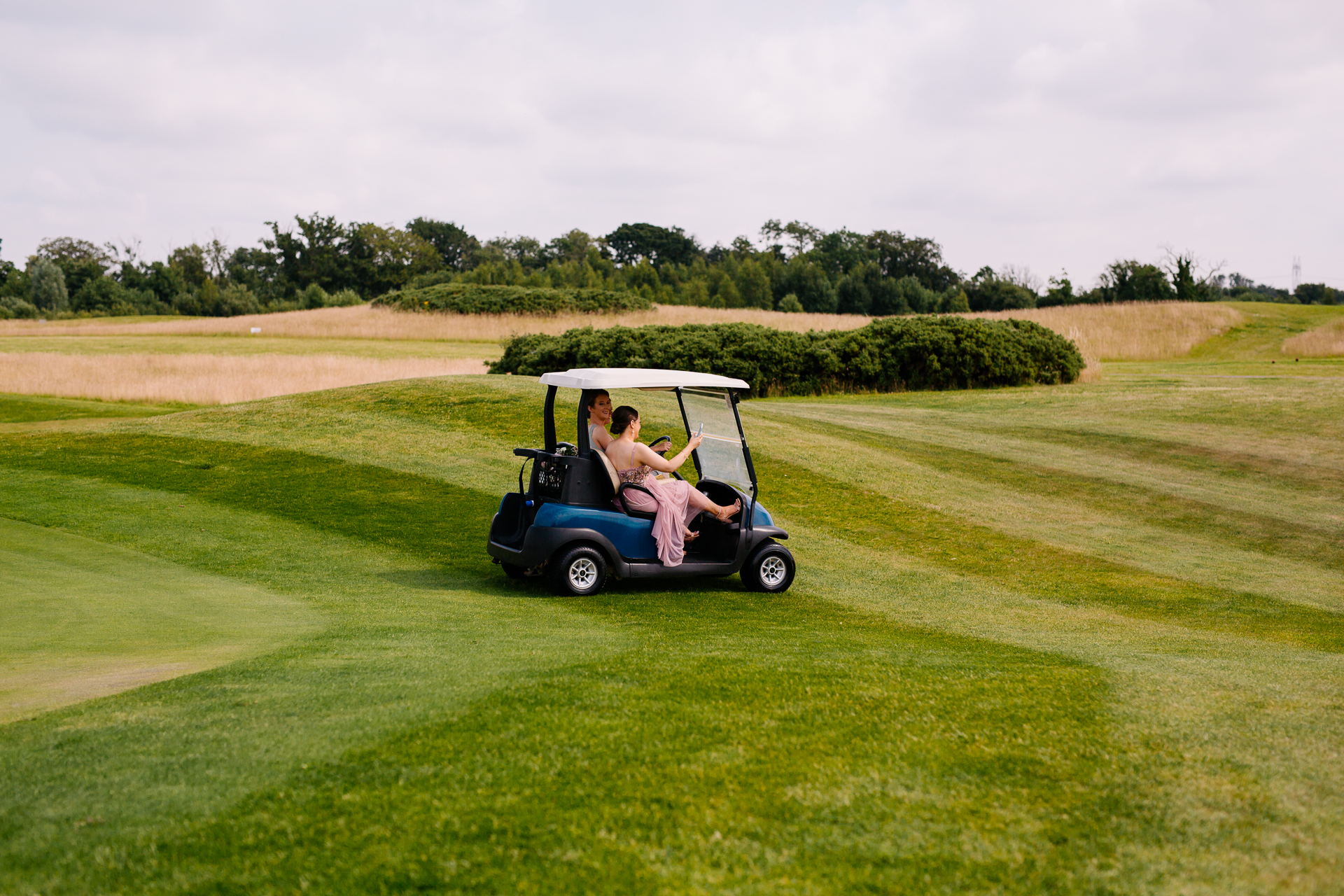 A couple of people in a golf cart on a golf course