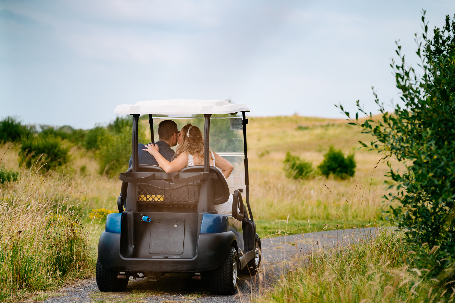 A couple people in a golf cart