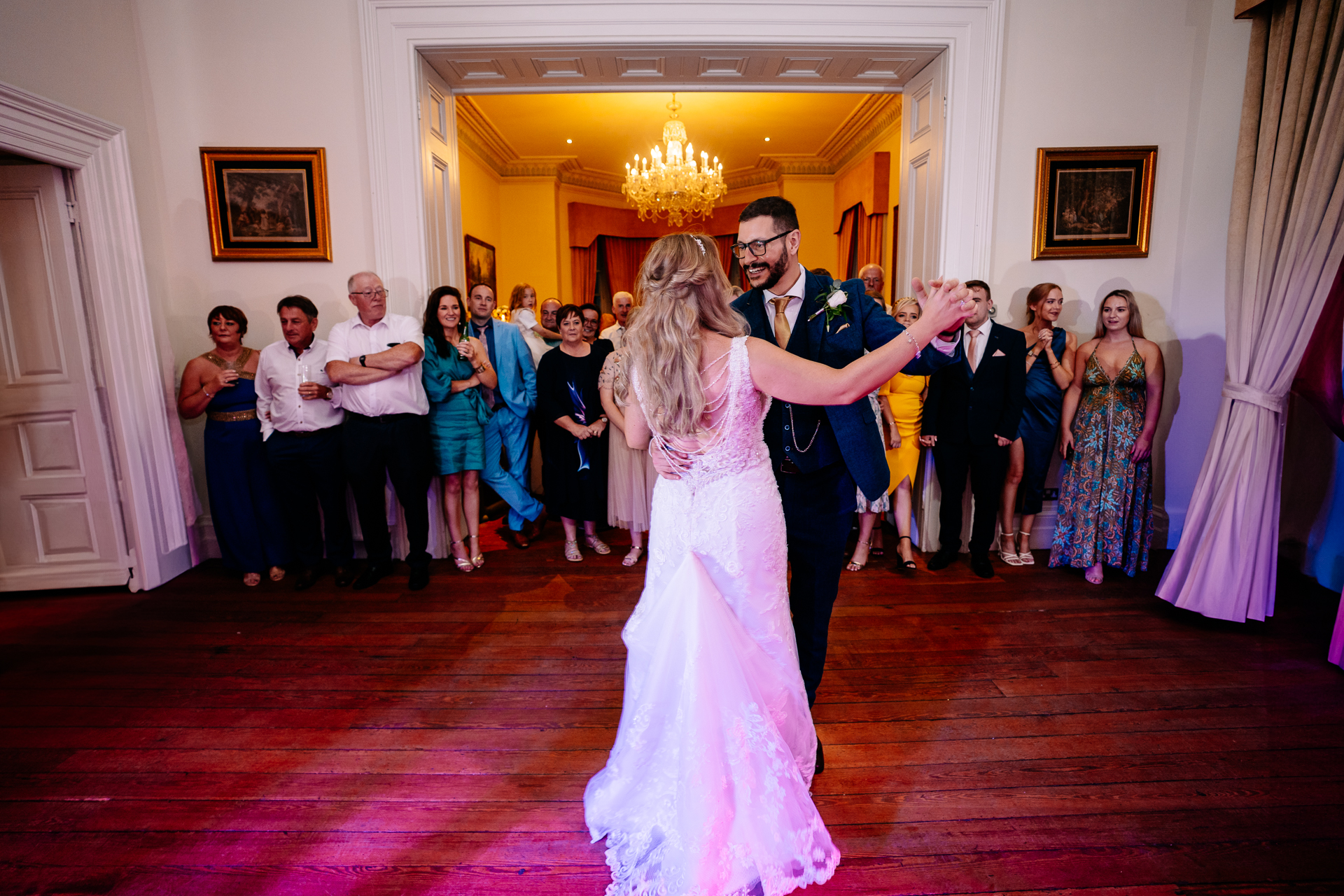 A man and woman dancing in a room with a group of people