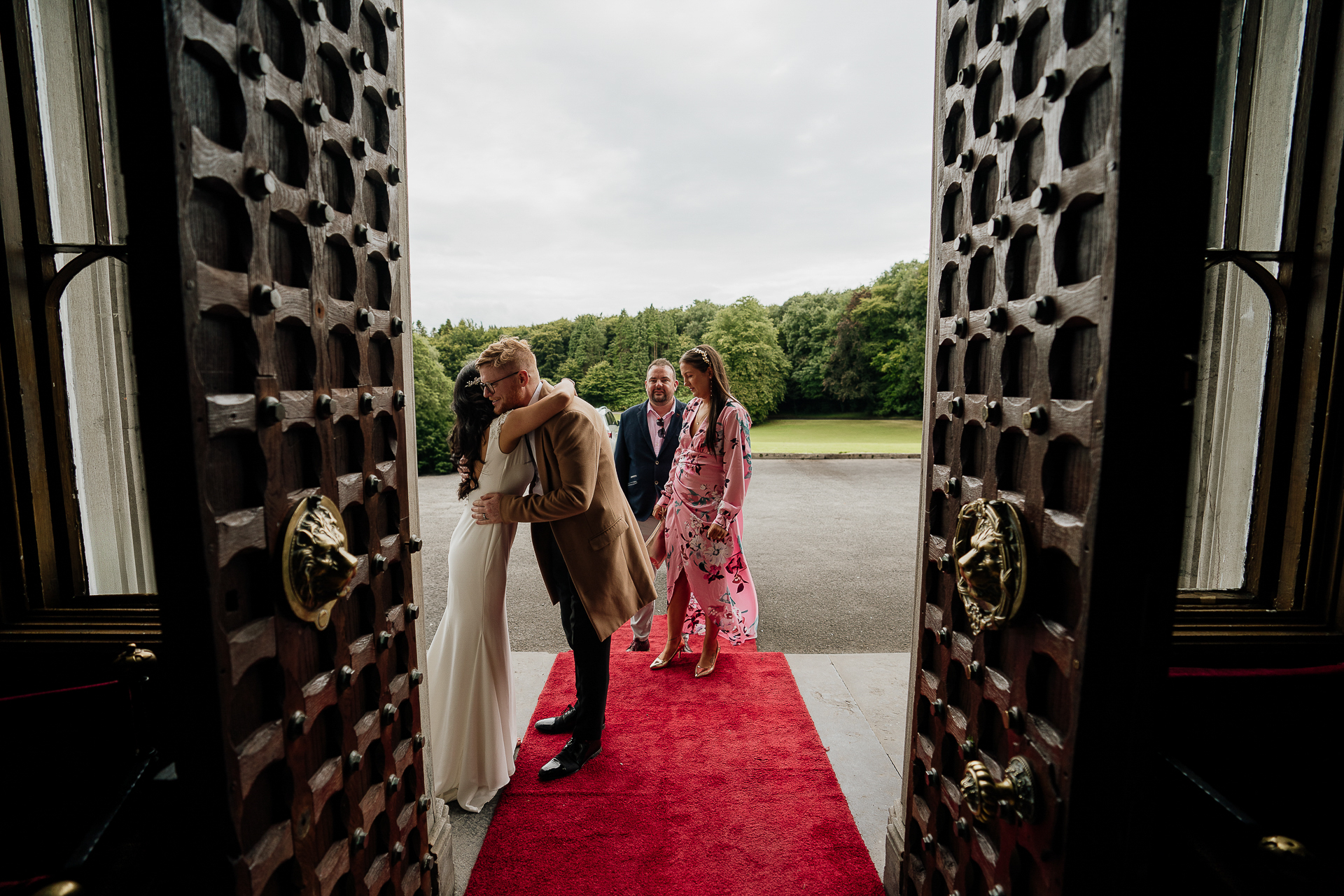 A group of people walking down a red carpet