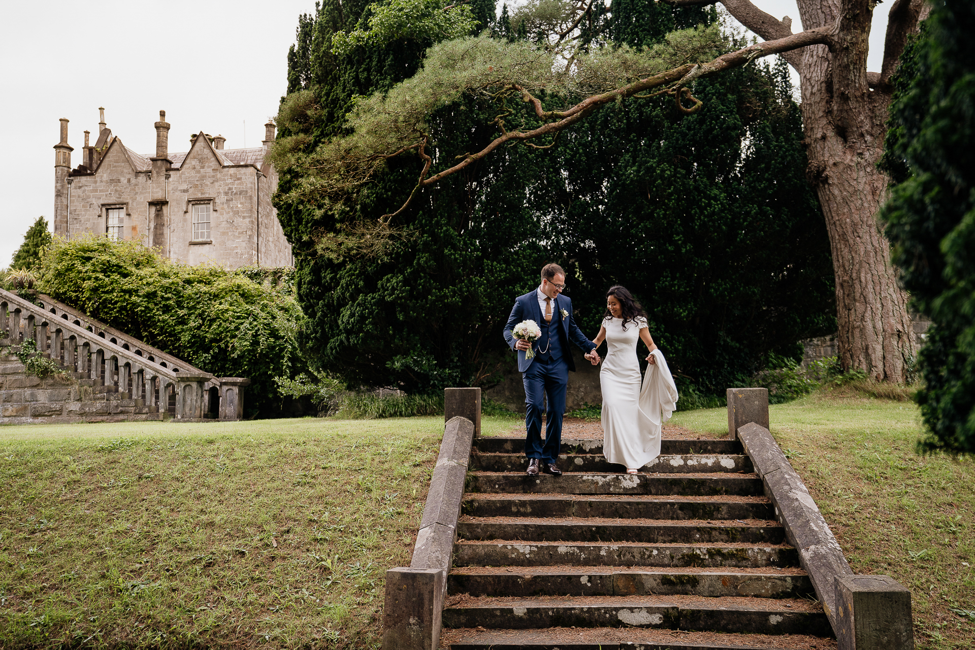 A man and woman walking down a flight of stairs