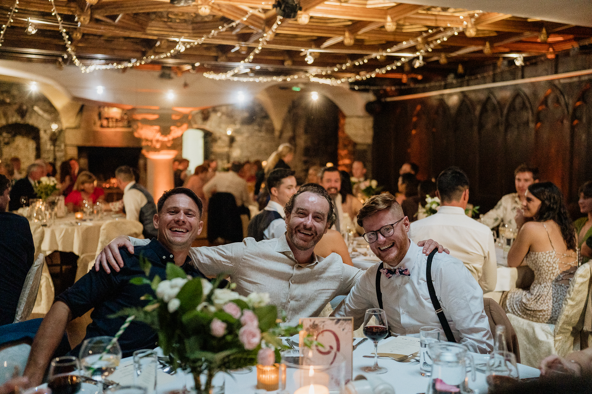 A group of people sitting at a table with flowers