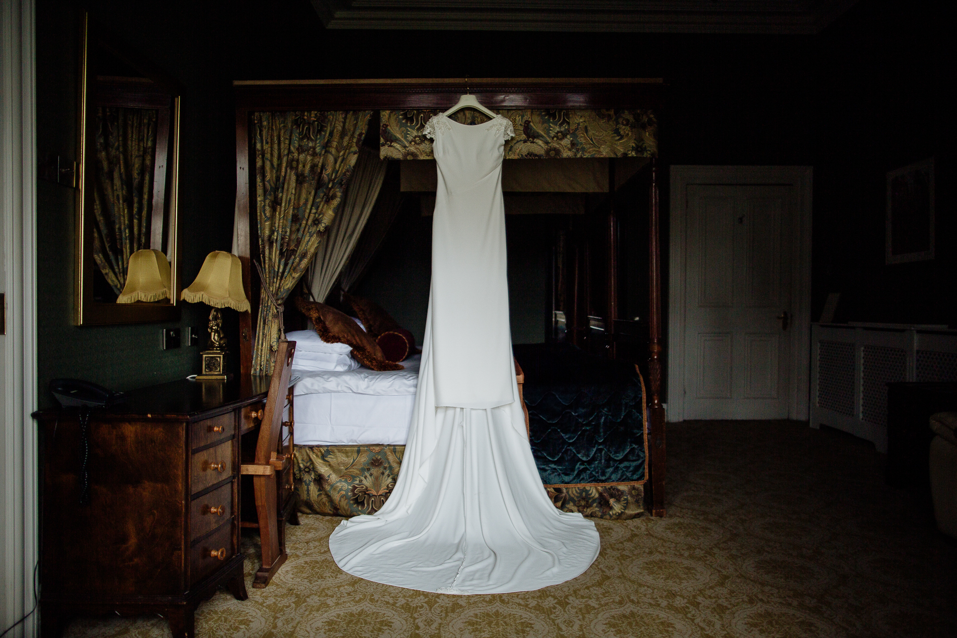 A person in a white dress in a bedroom