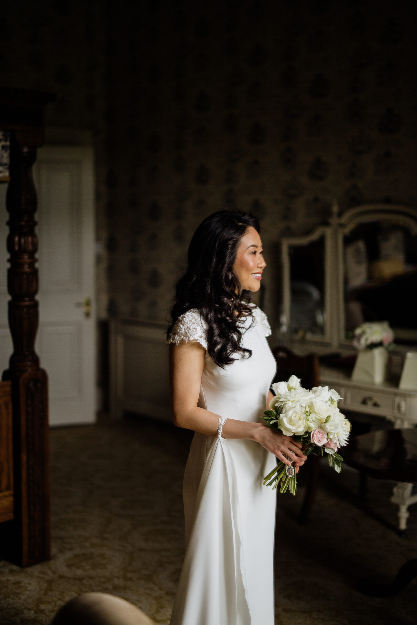 A woman in a wedding dress holding a bouquet of flowers