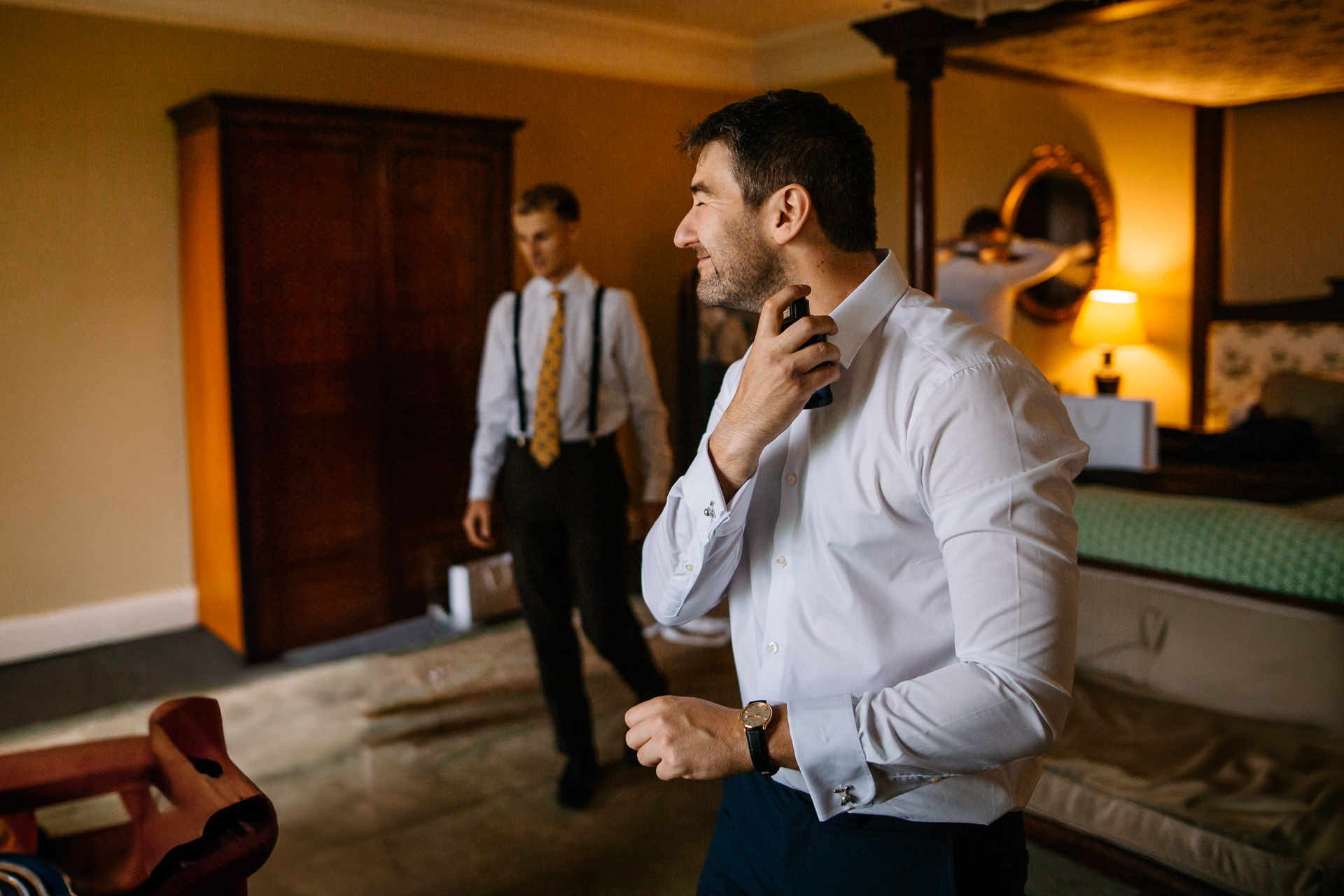 A man in a white shirt and tie talking on a cell phone