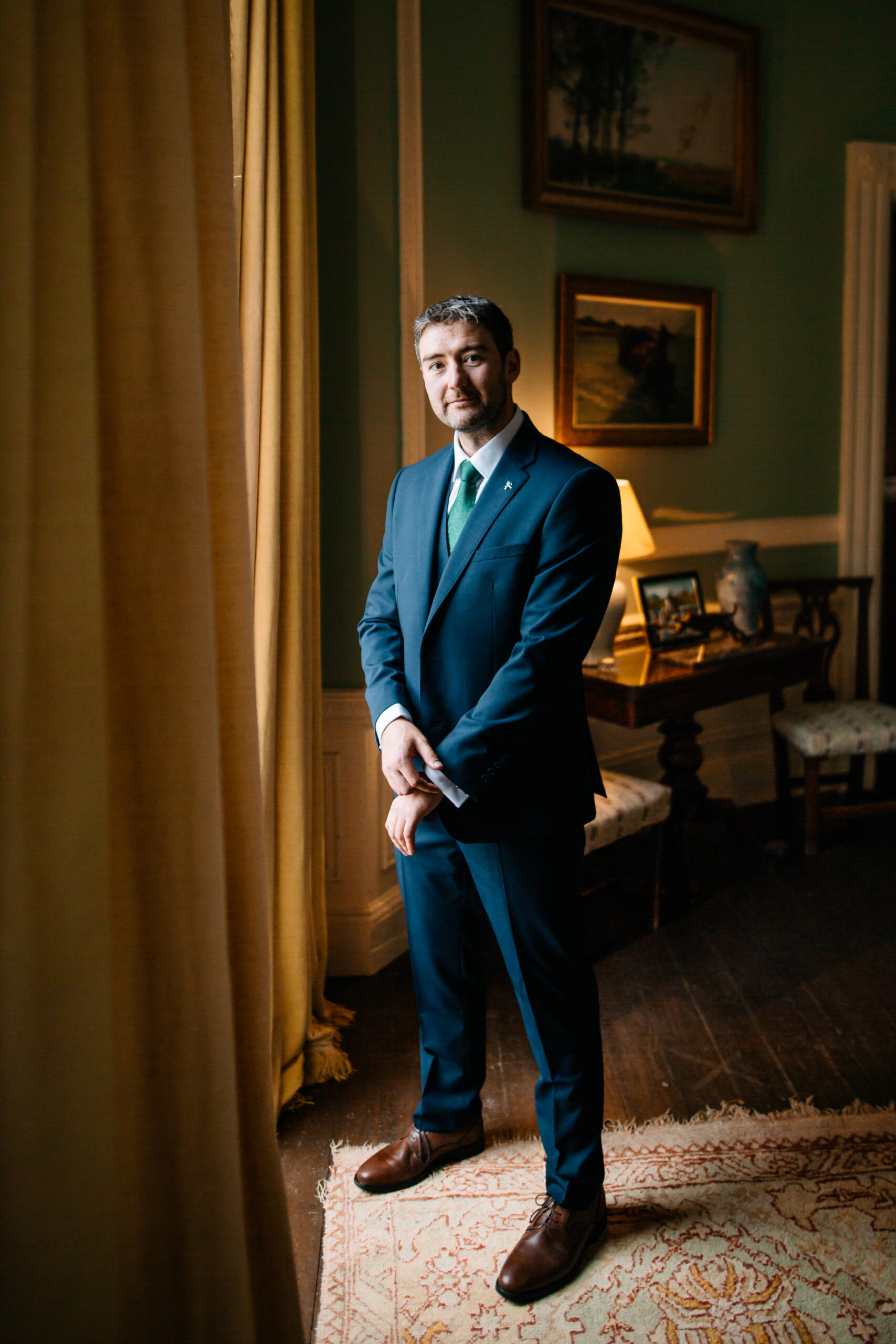 A man in a suit standing in a room