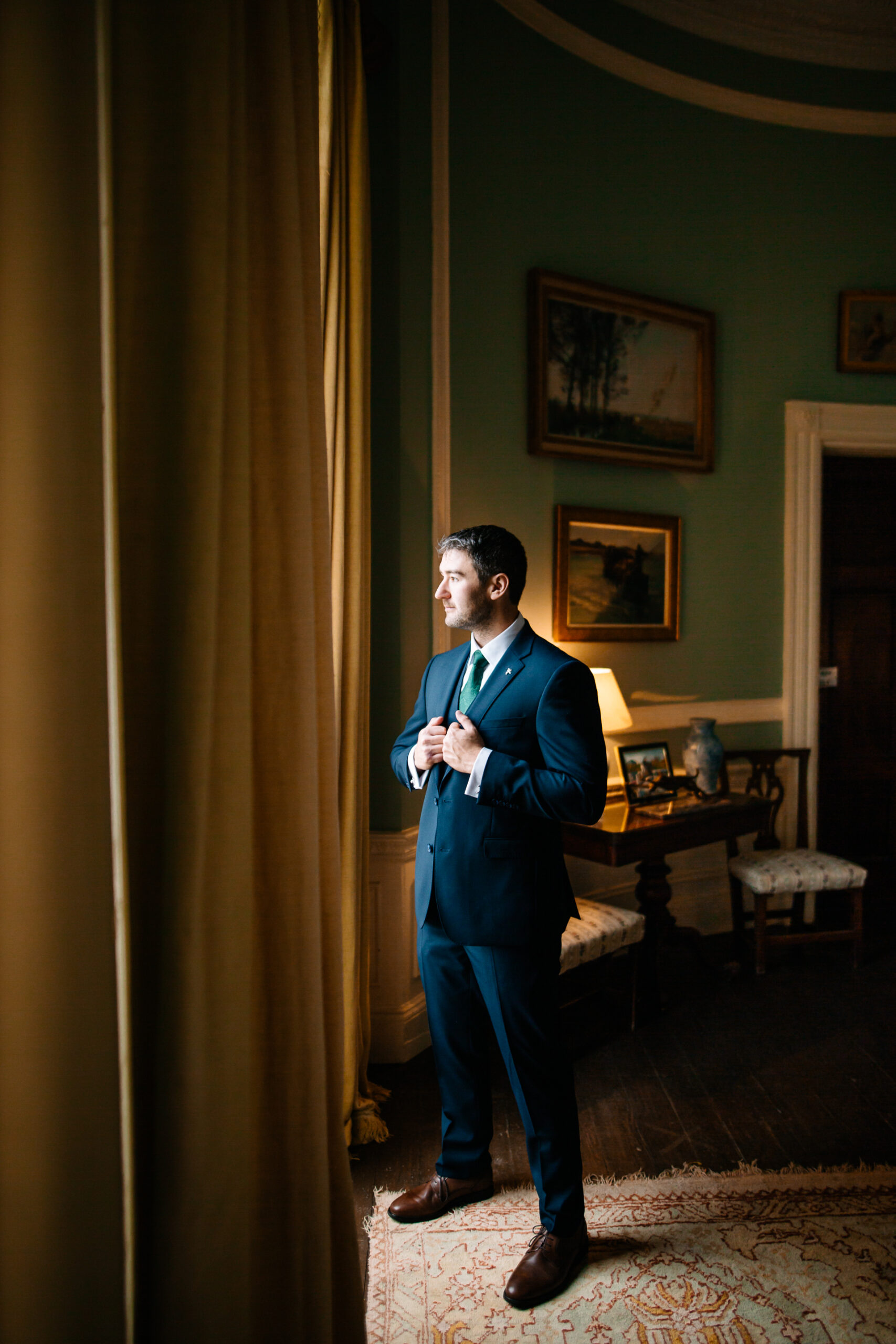 A man in a suit standing in a room