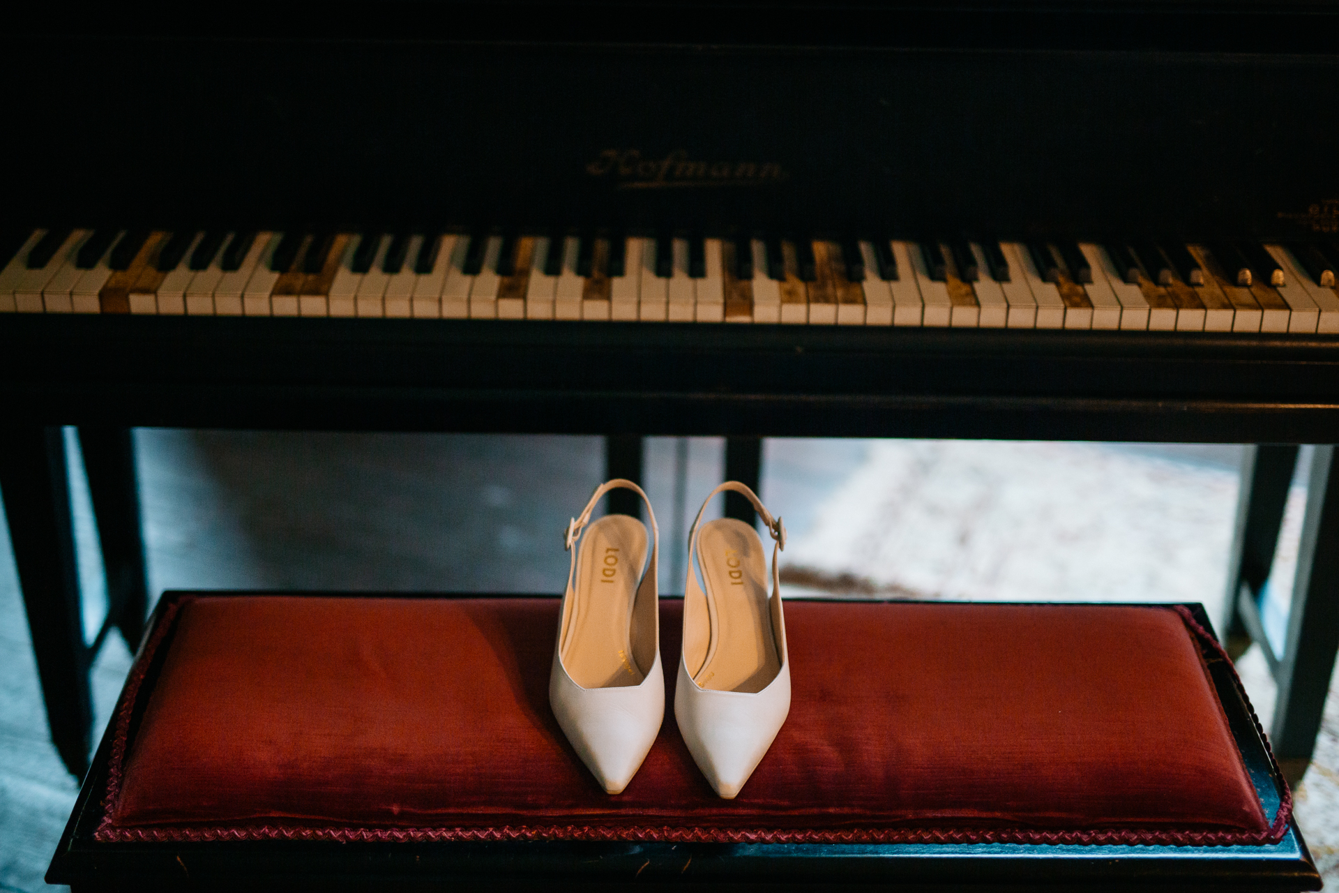 A pair of white shoes on a piano