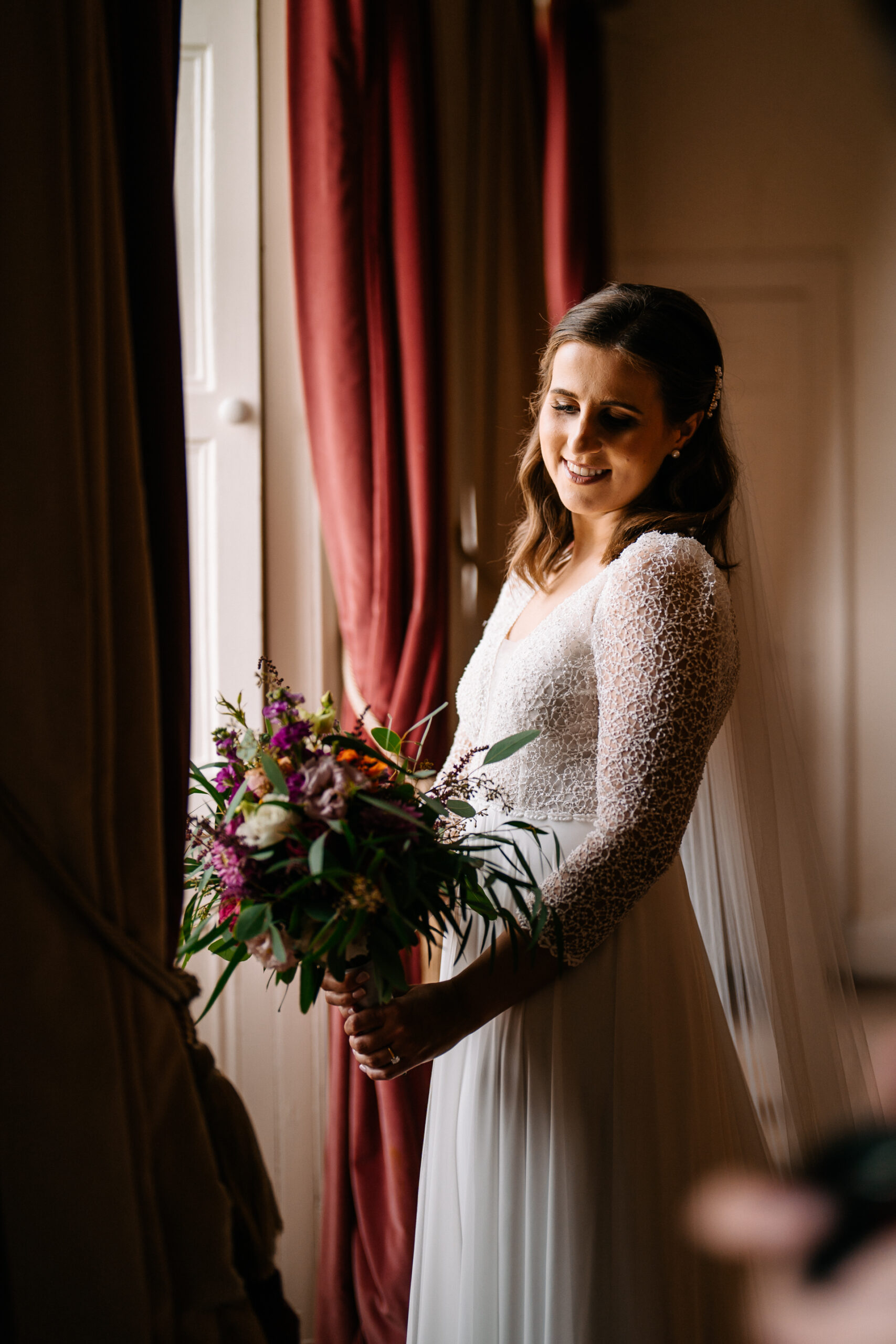 A person in a white dress holding a bouquet of flowers