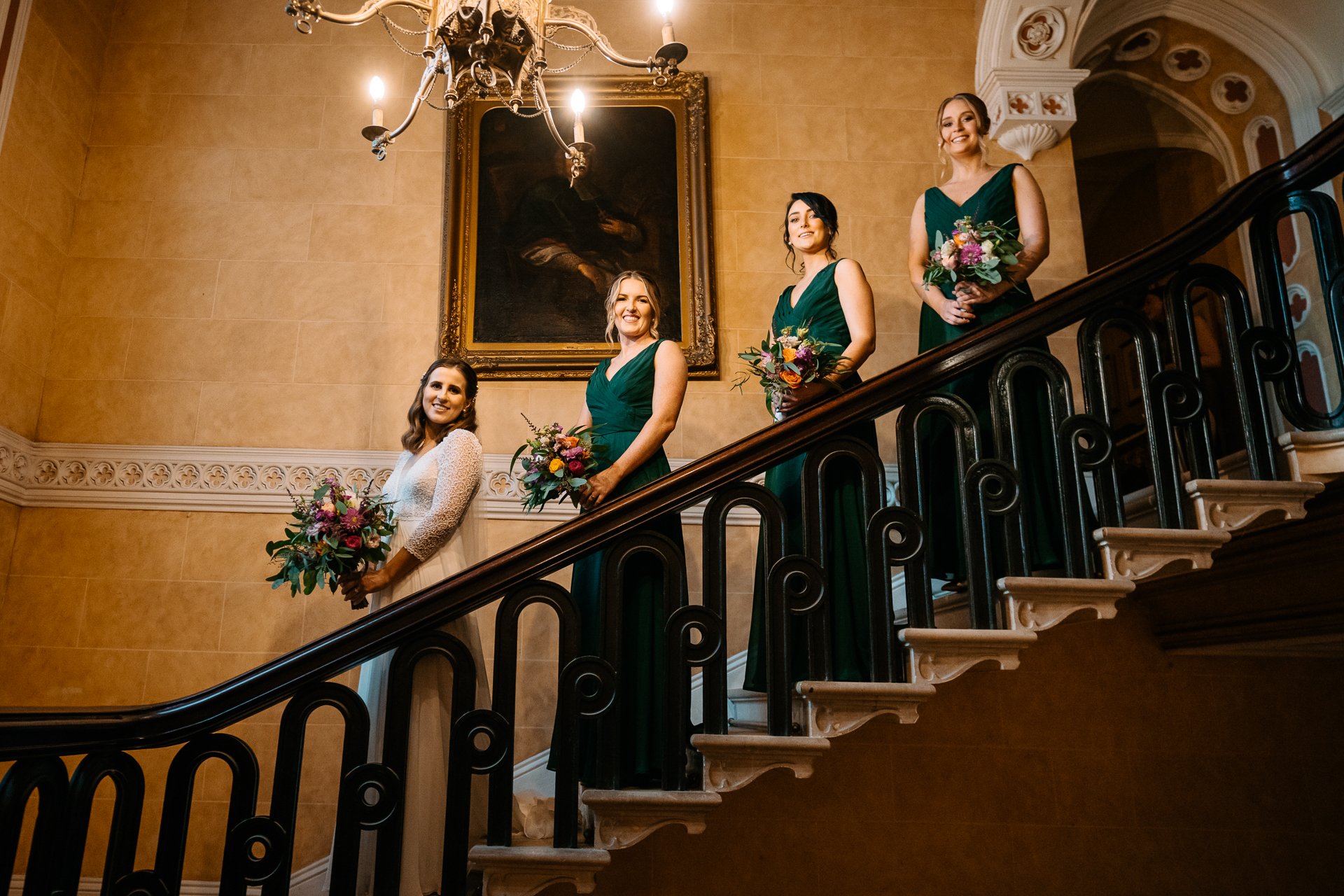 A group of women in dresses standing on a staircase