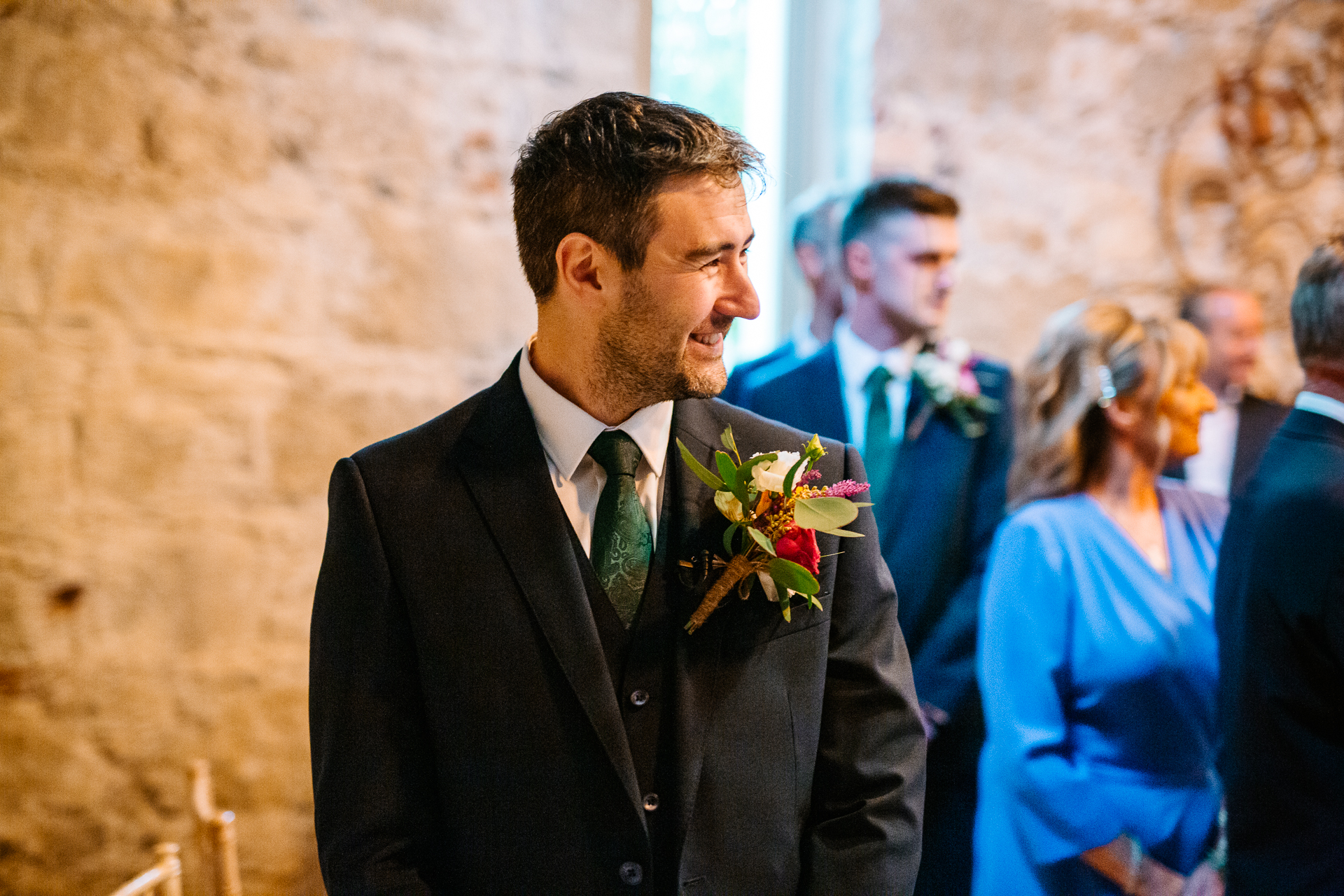 A man in a suit holding a bouquet of flowers