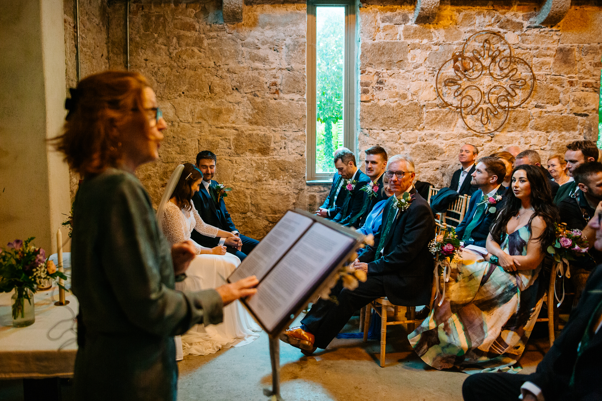 A woman standing in front of a group of people sitting in chairs