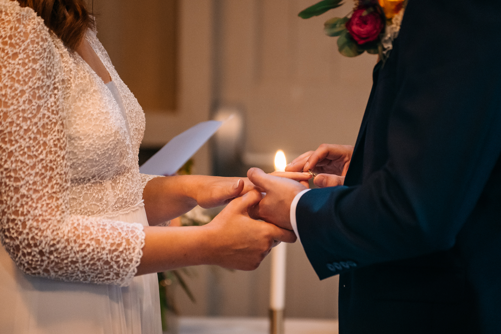 A man and woman holding a candle