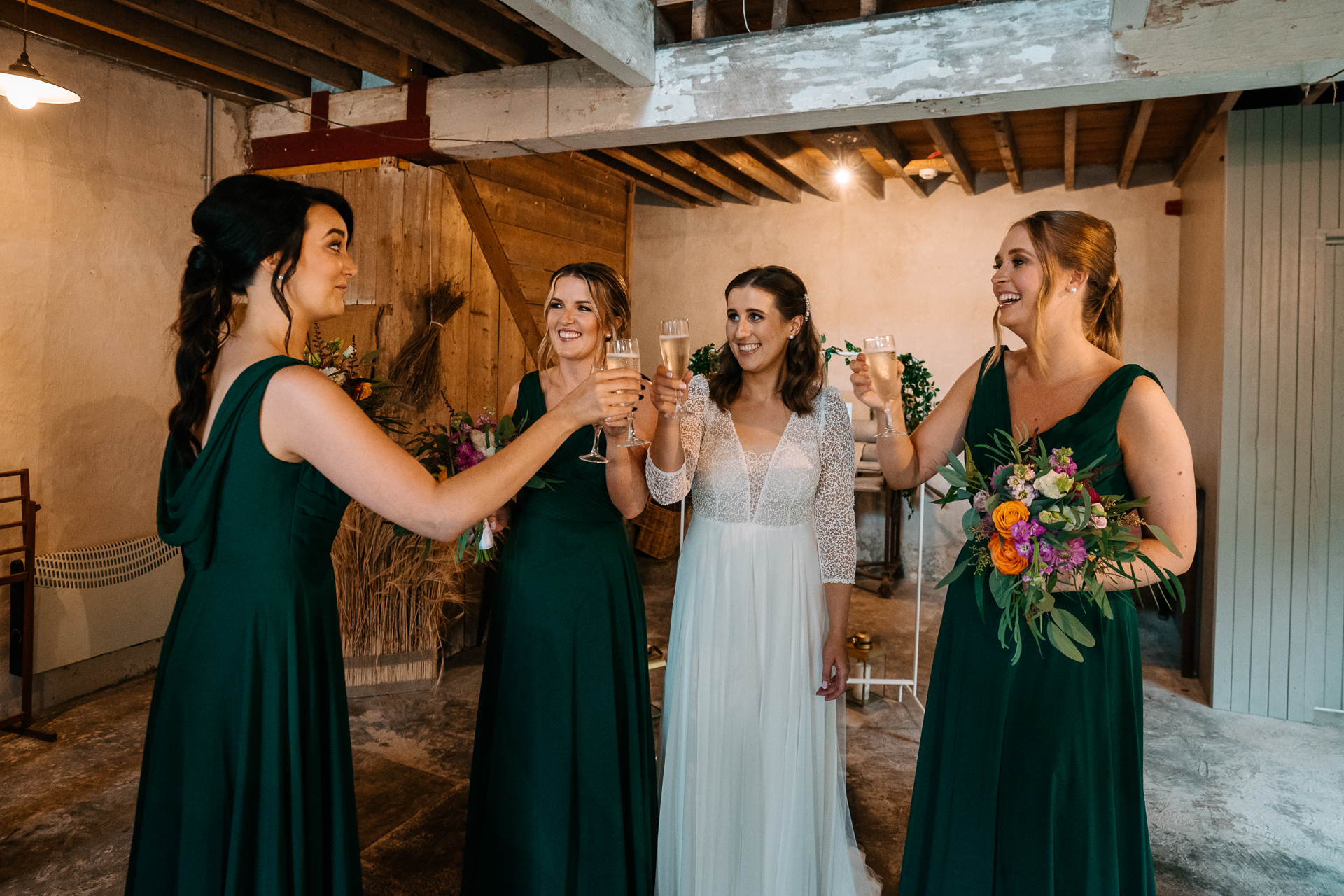 A group of women in dresses holding wine glasses