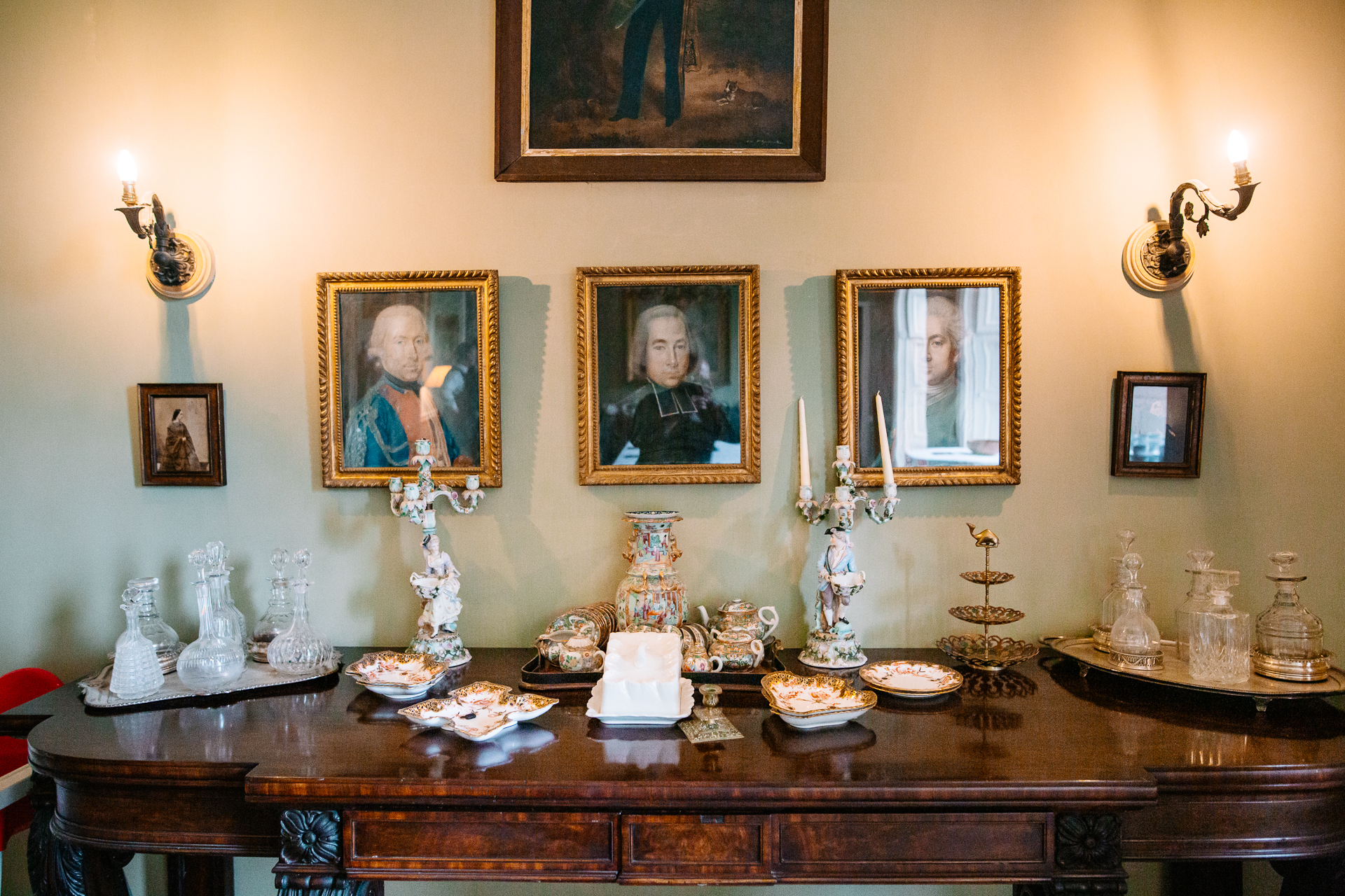 A table with candles and pictures on it