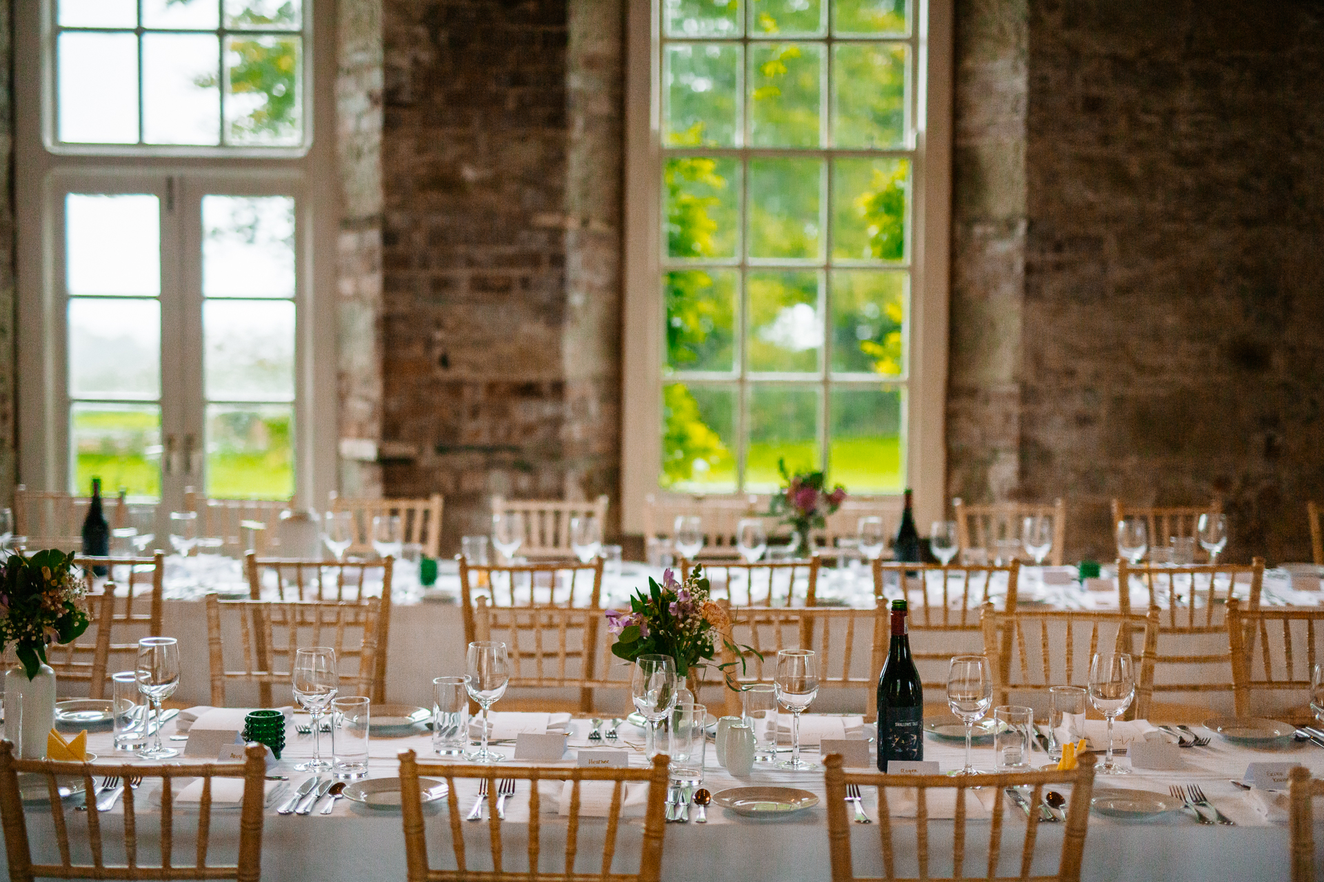 A large dining room with many wine glasses on the table